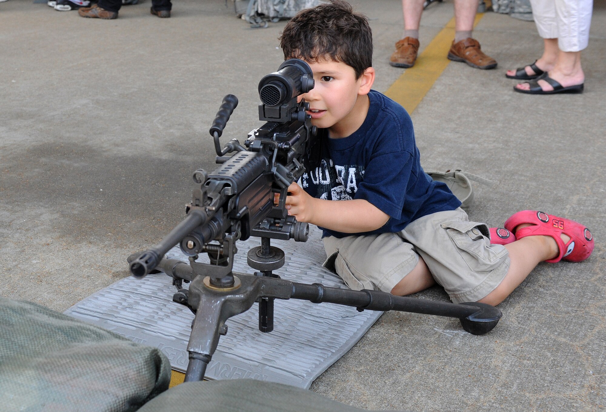 LANGLEY AIR FORCE BASE, Va. - Carlos Garriz, 5, looks through the scope of an M249 squad automatic weapon during the AirPower over Hampton Roads April 25. This annual event helps educate the public on Air Force capabilities and show appreciation to the local community. (U.S. Air Force photo/Airman 1st Class Gul Crockett)

