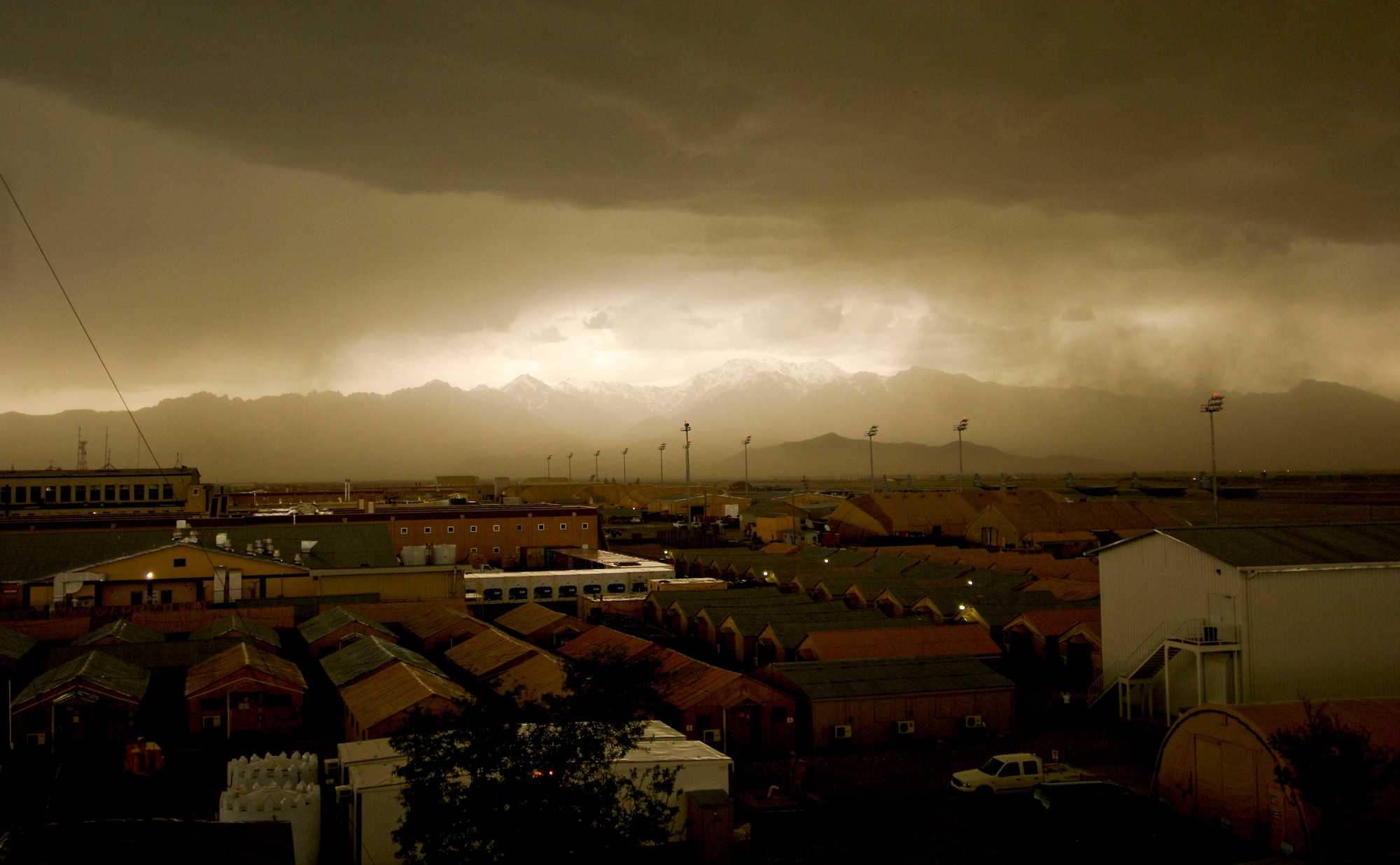 A storm rolls into Bagram Air Field, Afghanistan, April 20.  The 455th Expeditionary Operations Support Squadron, combat weather team, uses a variety of techniques to predict weather. They use a Mark IV satellite and visual reference to determine type and severity of storm to better prepare personnel on BAF to maintain mission effectiveness. Rainstorms are frequent this time of year and have the ability to change the landscape to include rivers and streams. With the lack of drainage systems, floods occur regularly throughout the southeast region of Afghanistan. Precipitation in east and southeast regions is about forty centimeters per year. (U.S. Air Force photo/ Senior Airman Erik Cardenas)(Released)