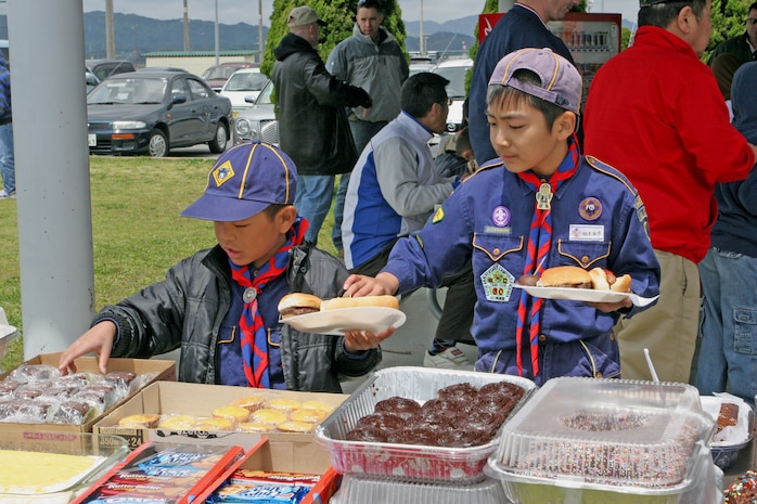 Local Japanese scouts grab something to eat after a long morning of fun activities at Penny Lake here April 26. The children could participate in activities that included knot tying, an obstacle course, ultimate Frisbee, tug-of-war, sack races and three-legged races.