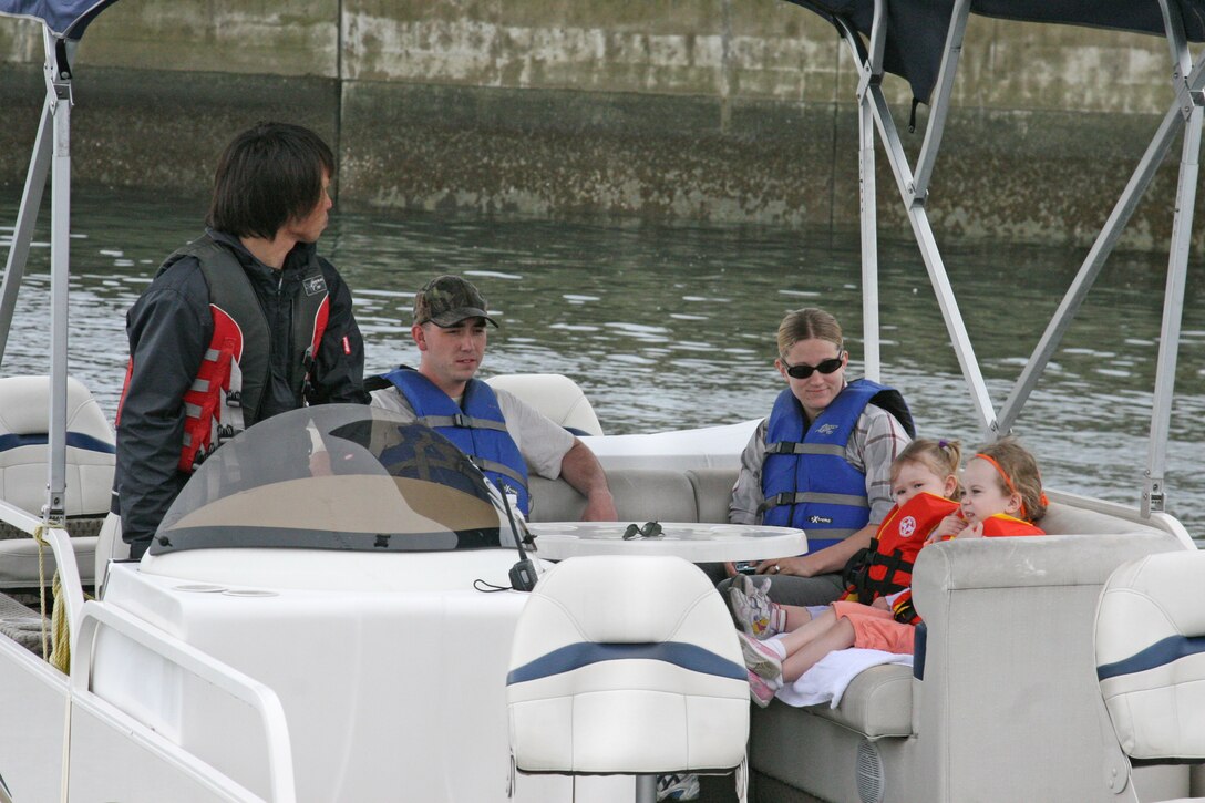 A pontoon boat pulls away from the dock at the season opening of Fish Tales Marina here April 25. In addition to the pontoon boat, Jet Skis, ocean kayaks, sailboards and sailboats are also available for use.