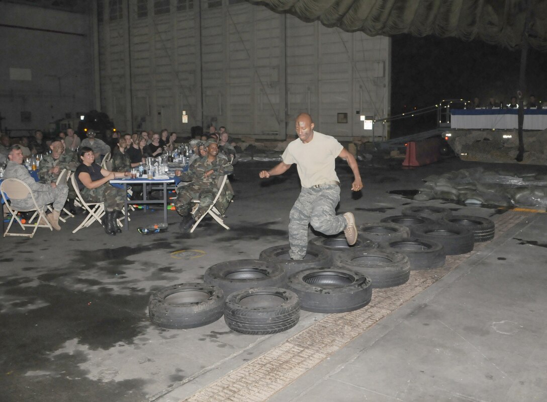 KADENA AIR BASE, Japan -- Airman 1st Class Jonnathan Clay runs through the obstacle course to get to the grog bowl during a combat dining out here April 25. The dining out commemorated Operation Eagle Claw, an aborted rescue mission April 24, 1980, into Iran to recover more than 50 American hostages captured after a group of Islamist students took over the American embassy in Tehran Nov.  4, 1979. The mission resulted in the crash of two aircraft and the deaths of eight American service members at a remote site deep in Iranian territory known as Desert One. (U.S. Air Force photo by Tech. Sgt. Aaron Cram)