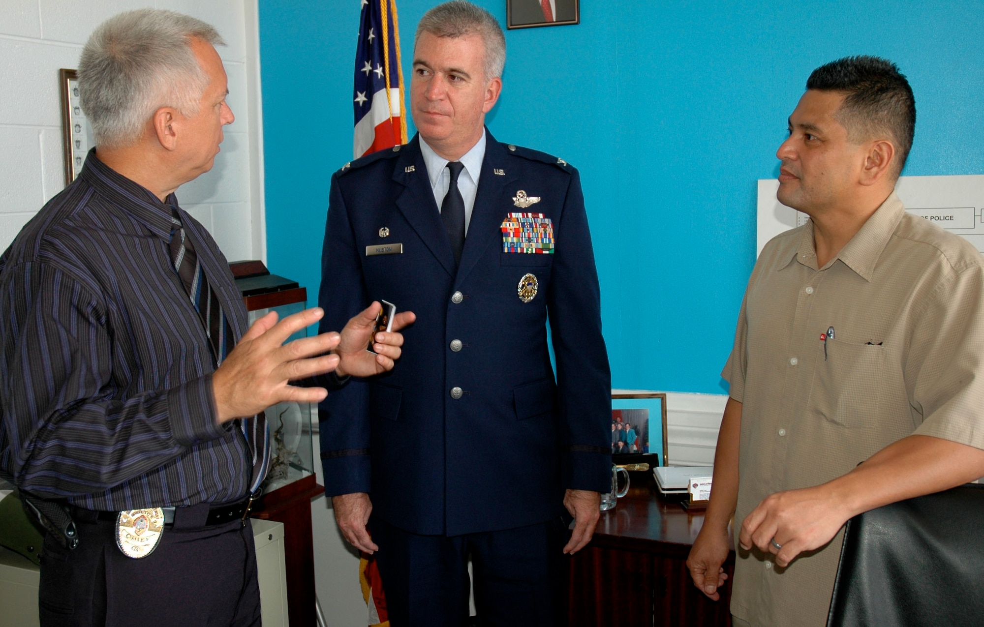 Guam Police Department Chief Paul Suba talks to Col. Robert “Randy” Huston, 624th Regional Support Group commander, about the advantages of having Air Force Reservists like Chief Master Sergeant Maurice Sayama (right) in his department.  Chief Sayama, an air freight superintendent for the Reserve, is currently a lieutenant with the police department where he has been working for 23 years.  At least a dozen other Guam Air Force Reservists are employed by the GPD.  (U.S. Air Force photo/Capt. Christy Stravolo) 