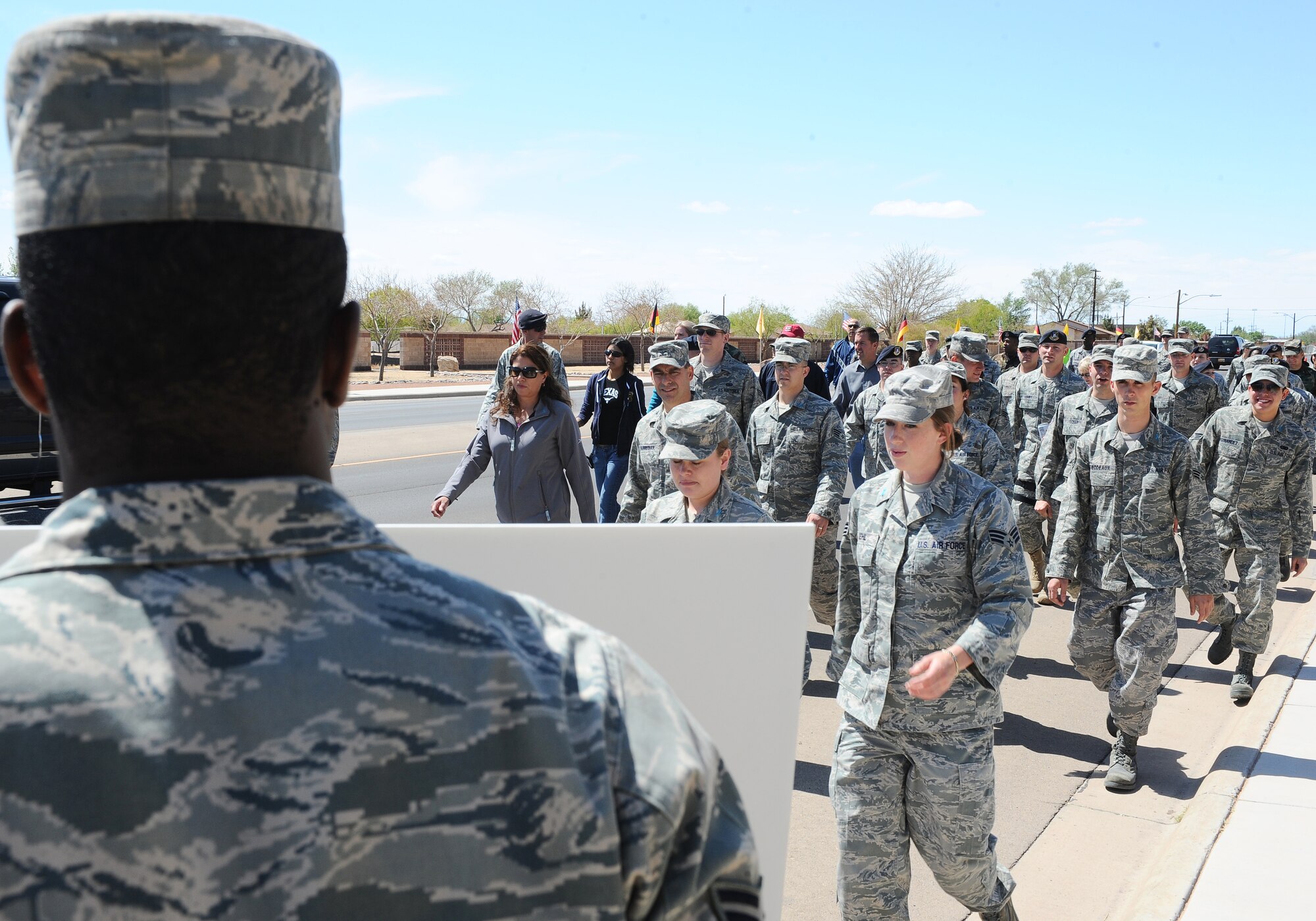 Volunteers involved in the "My Strength is for Defending" walk for Sexual Assault Awareness hold signs, April 17, along the route depicting statistics on sexual assault across the U.S. The walk informed Holloman Air Force Base personnel of Sexual Assault issues. (U.S. Air Force photo/ Airman 1st Class DeAndre Curtiss)