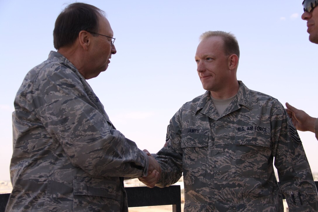 Tech. Sgt. Gregory James shakes hands with Lt. Gen Charles E. Stenner, commander, Air Force Reserve Command.  General Stenner was visiting deployed Reservists who are serving AEF tours in support of OIF.  Sergeant James is from the 932nd Airlift Wing, Scott AFB, IL. Courtesy photo.