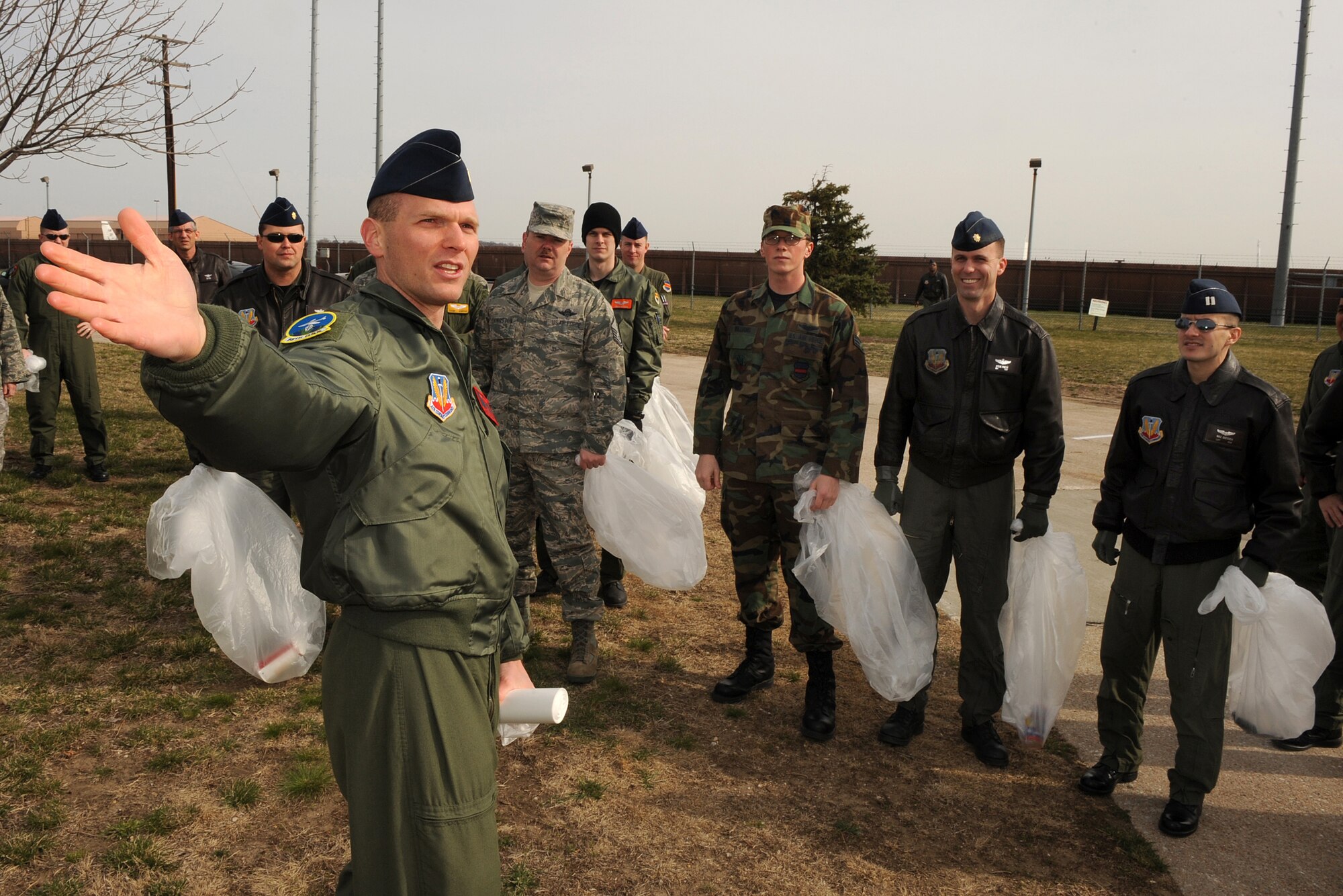 OFFUTT AIR FORCE BASE, Neb. - 2nd Lt. Samuel Greenwell, 338th Combat Training Squadron, instructs 338th CTS Airmen on cleanup procedures during base cleanup here April 10. Members of the 55th Wing participated in the annual base cleanup by policing the areas around their work centers. U.S. Air Force Photo by Josh Plueger