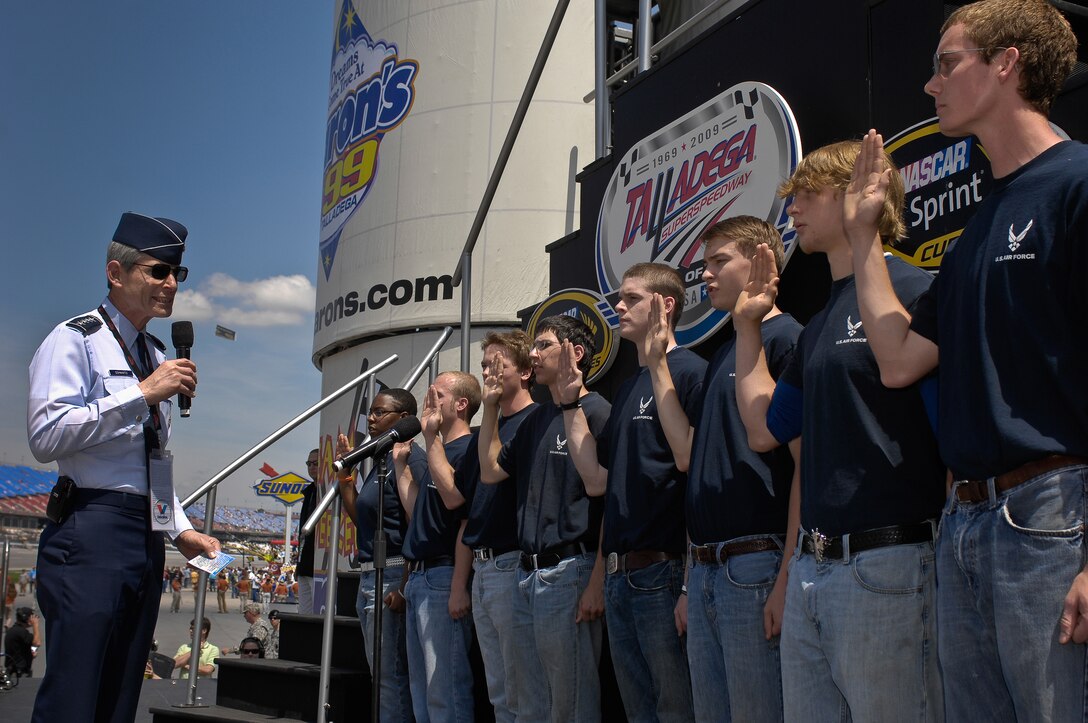 Air Force Chief of Staff Gen. Norton Schwartz performs a delayed enlistment program swear-in prior to the start of the NASCAR race April 26 at the Talladega Superspeedway in Talladega, Ala.  General Schwartz was at the race to watch the #43 car run.  The car, driven by Reed Sorenson, featured the Air Force primary paint scheme for the first time.  (U.S. Air Force photo/Master Sgt. Scott Reed)