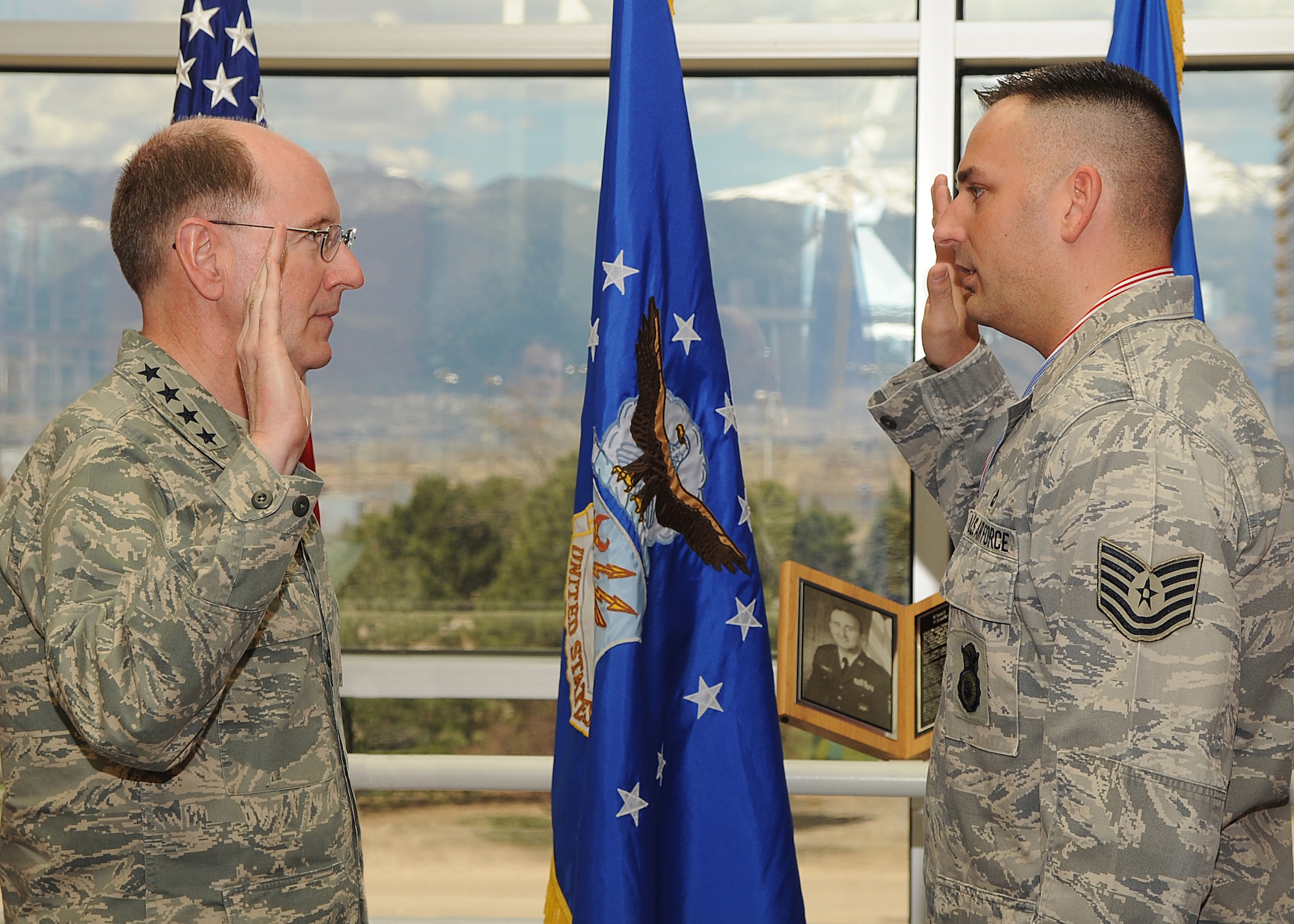 PETERSON AIR FORCE BASE, Colo. -- Gen. C. Robert Kehler, commander of Air Force Space Command, re-enlists Tech. Sgt. Nikki Drago, a flight chief for the 791st Missile Security Forces Squadron at AFSPC Headquarters April 23. Sergeant Drago was recently named one of the command's Outstanding Airmen of the Year. (U.S. Air Force photo by Duncan Wood)