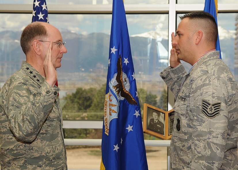PETERSON AIR FORCE BASE, Colo. -- Gen. C. Robert Kehler, commander of Air Force Space Command, re-enlists Tech. Sgt. Nikki Drago, a flight chief for the 791st Missile Security Forces Squadron at AFSPC Headquarters April 23. Sergeant Drago was recently named one of the command's Outstanding Airmen of the Year. (U.S. Air Force photo by Duncan Wood)
