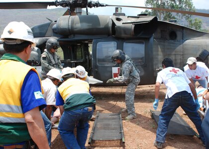 COMAYAGUA, Honduras - During an exercise at La Farge Cement Factory April 22, U.S. Army Sgt. Clayton Peterson (center), a flight medic from Joint Task Force - Bravo, directs the placement of accident victims for medical transport via HH-60 Blackhawk helicopter.  JTF-Bravo participated in FA-HUM '09 this week, a multinational exercise for disaster response agencies throughout Central America.  (U.S. Air Force photo/Tech. Sgt. Rebecca Danét)  