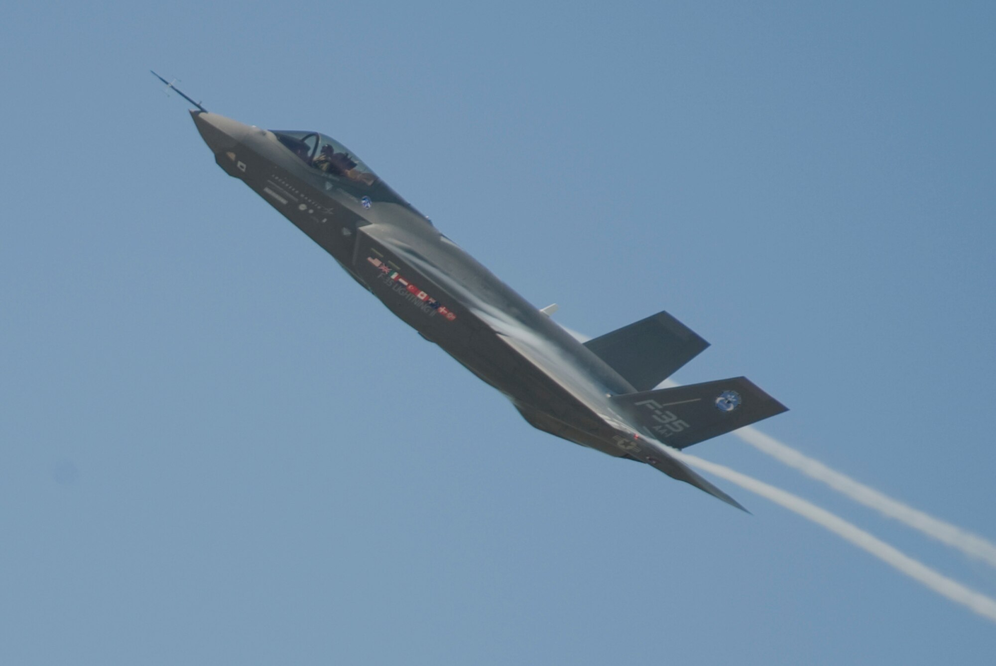 The F-35 Lightning II Joint Strike Fighter test aircraft AA-1 banks over the flightline sending contrails streaming off the wings during its sortie April 23 at Eglin Air Force Base, Fla. The aircraft's first arrival at the base was to provide a showcase to base members and the local community. (Courtesy photo) 
