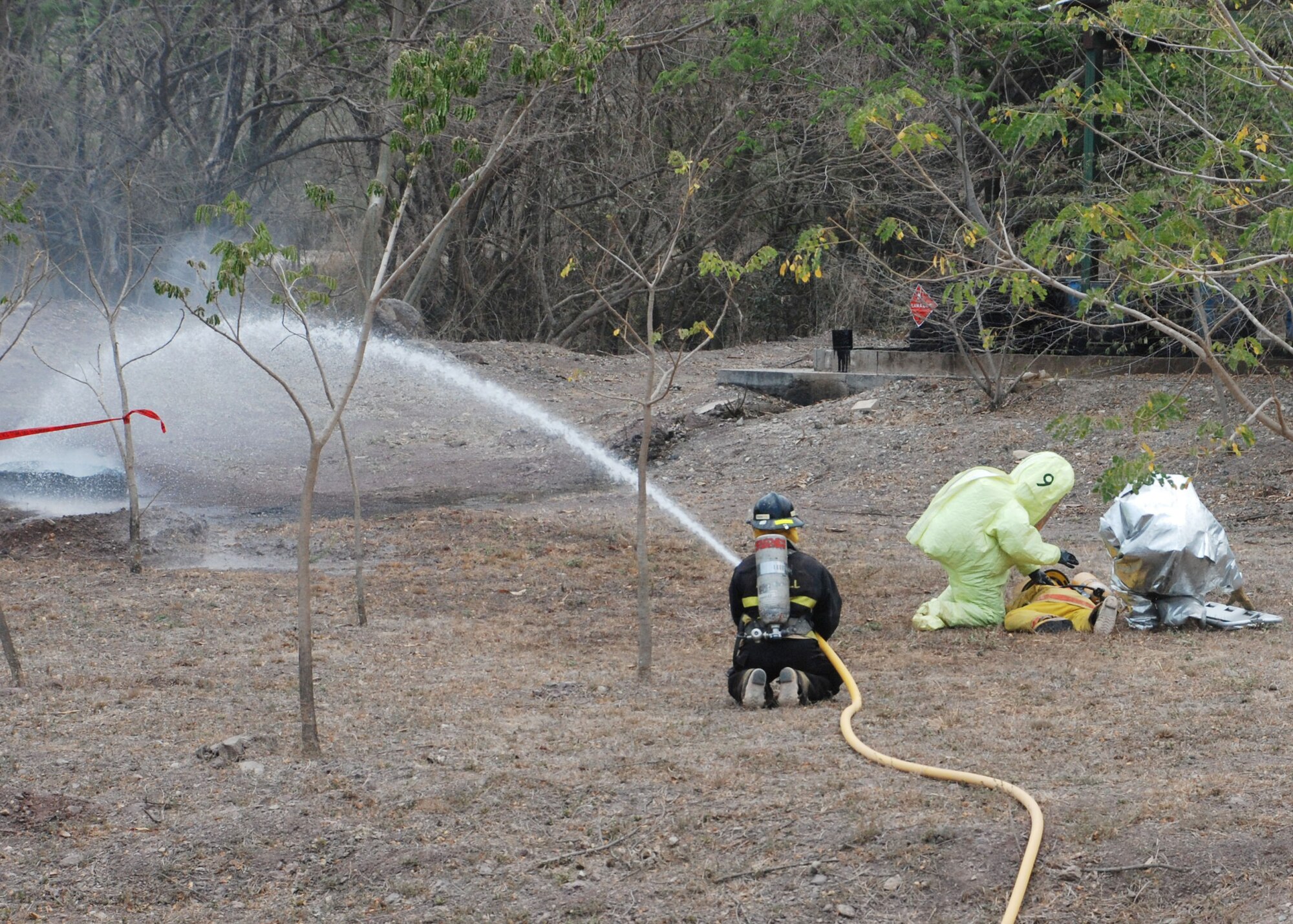 COMAYAGUA, Honduras - Firefighters, HazMat crews and military members responded to a simulated explosion at La Farge Cement Factory here April 22, in which three simulated victims were seriously injured.  First responders from throughout Central America were here this week to participate in FA-HUM '09, a multinational disaster response exercise coordinated by COPECO, Honduras' disaster response agency.  (U.S. Air Force photo/Tech. Sgt. Rebecca Danét)