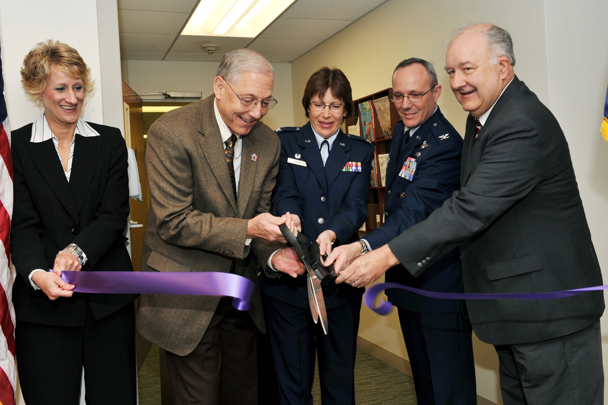 OFFUTT AIR FORCE BASE Neb. - (From left to right,) Cindy Sestak, assistant director of the Nebraska-Western Iowa health care system; Al Wasko, director of the Nebraska-Western Iowa health care system; Col. Linda Eaton, 55th Medical Group commander; Col. Robert Maness, 55th Wing vice commander; and Ed Babbitt, mayor of Bellevue, cut the ribbon during the grand opening ceremony of the new Veterans Affairs Community-based outpatient clinic, located inside the Ehrling Bergquist Clinic here April 25. With the opening of the VA outpatient clinic, veterans living in the Bellevue area no longer have to travel to Omaha or other cities to receive VA medical care. U.S. Air Force photo by Charles Haymond
 