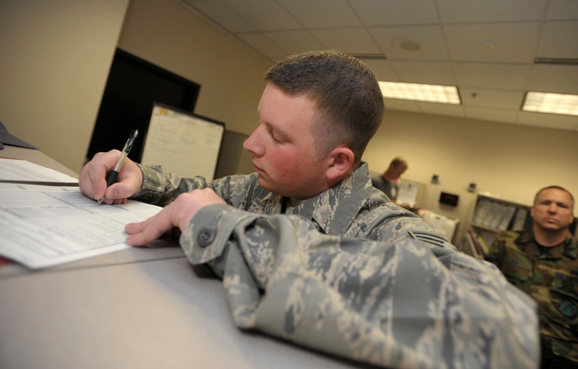 Senior Airman Timothy Eddy finishes up some final paperwork Monday before deploying to Southwest Asia in support of overseas contingency operations. He and  other Airmen from the 931st Air Refueling Group, an Air Force Reserve unit at McConnell Air Force Base, Kan., are scheduled to depart for their deployment Tuesday. Airman Eddy is a crew chief assigned to the 931st Aircraft Maintenance Squadron. (U.S. Air Force photo/Tech. Sgt. Jason Schaap)