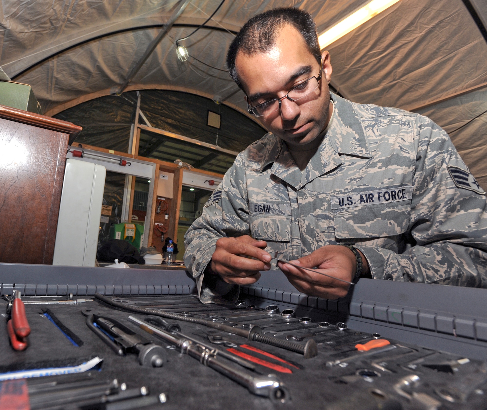 Senior Airman Fred Egan performs a daily tool inventory inspection April 20 at an air base in Southwest Asia. All tools are inspected within the tool shed prior to a shift change to ensure accountability. Airman Egan is a 746th Aircraft Maintenance Unit avionics technician. He hails from North Vernon, Ind., and is deployed from Youngstown Air Reserve Station, Ohio. (U.S. Air Force photo/Staff Sgt. Joshua Garcia) 
