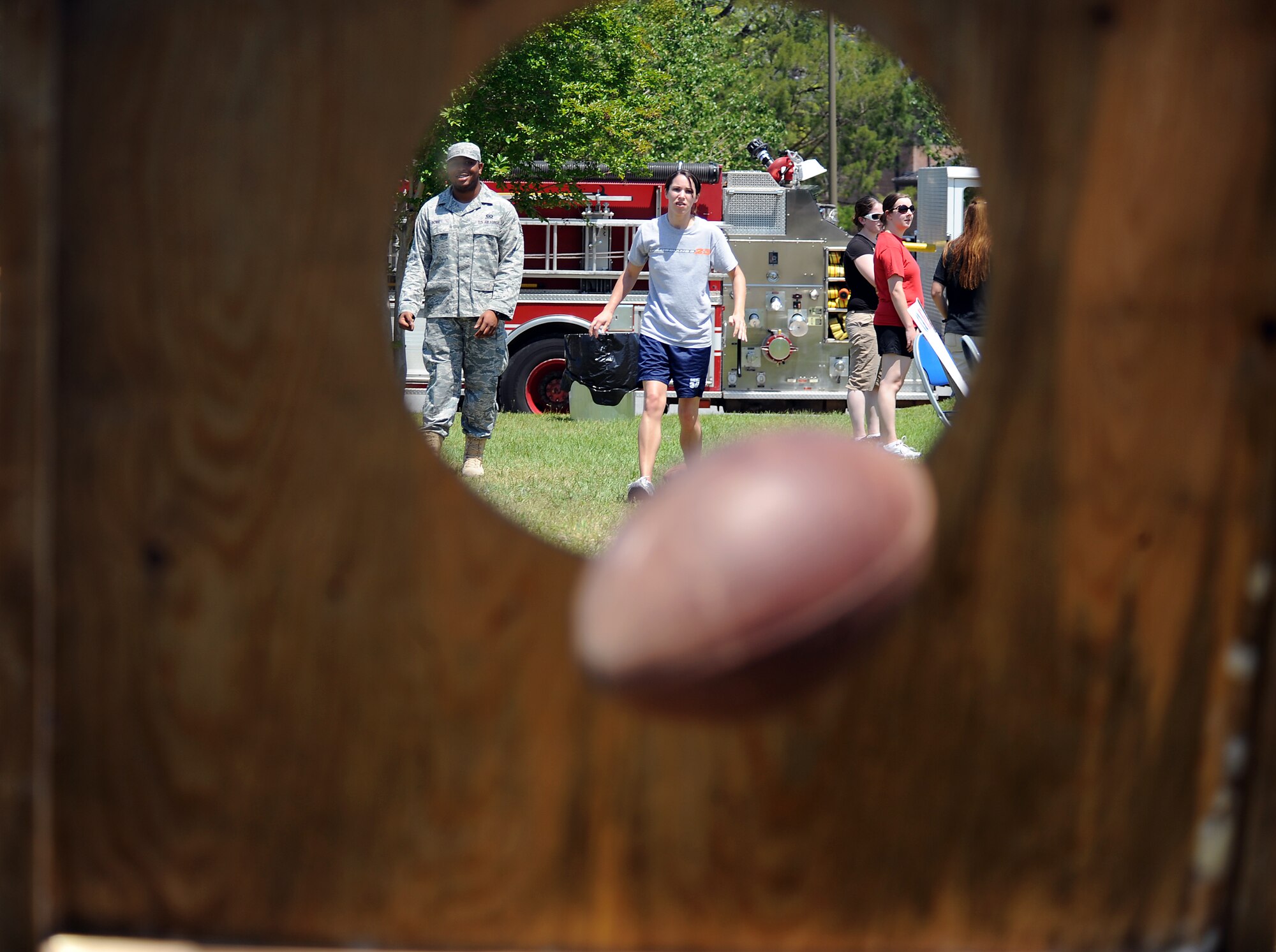 MOODY AIR FORCE BASE, Ga. -- Airman 1st Class Andrea Parker, 23rd Logistics Readiness Squadron logistics plans journeyman, throws a football through a target during Airmen Appreciation Day here April 24. Airmen enjoyed a day of recreational activities, free food, and live music. (U.S. Air Force photo by Airman 1st Class Joshua Green) 