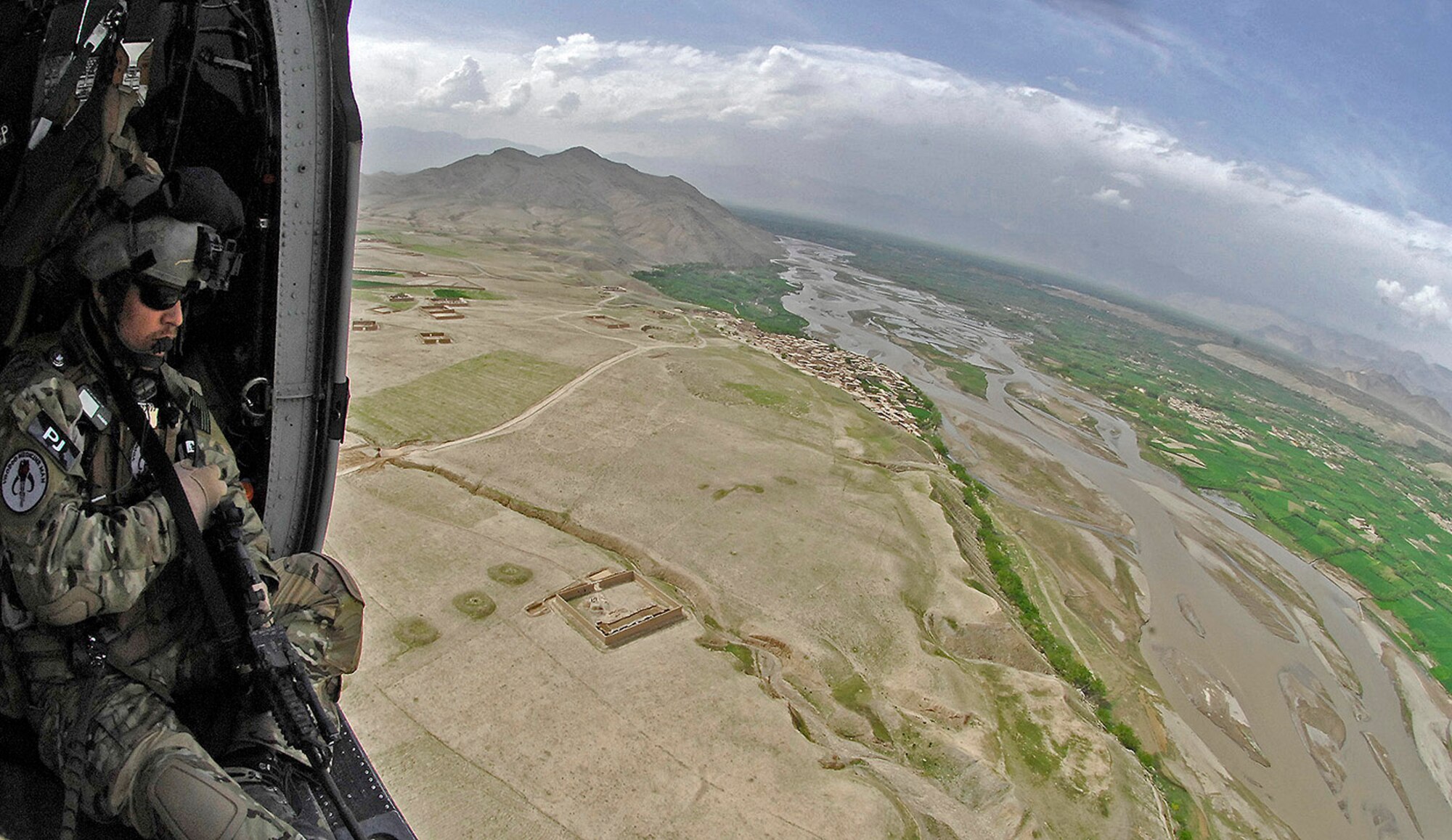 Tech. Sgt. Jedediah Smith surveys the landscape for threats during a training mission over Northeastern Afghanistan April 20. Sergeant Smith is a 101st Expeditionary Rescue Squadron pararescueman. (U.S. Air Force photo/Staff Sgt. Jason Lake) 
