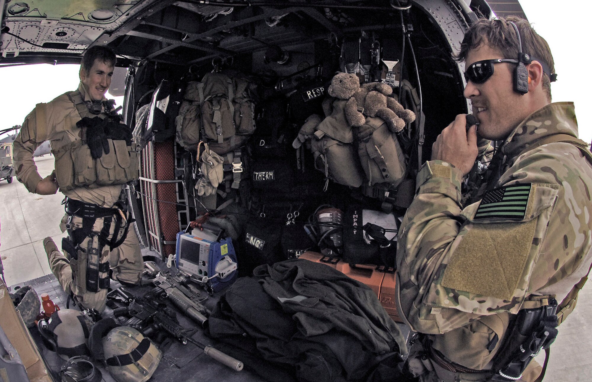 1st Lt. Brent McCall and Tech. Sgt. Jedediah Smith load up their gear for a training mission in Northeastern Afghanistan, April 20. In addition to an M-4 assault rifle, combat medical gear and body armor, Sergeant Smith also packs his four-year-old daughter Mia's pre-school class teddy bear. Lieutenant McCall is a 101st Expeditionary Rescue Squadron combat rescue officer, and Sergeant Smith is a 101st ERQS pararescueman. (U.S. Air Force photo/Staff Sgt. Jason Lake) 
