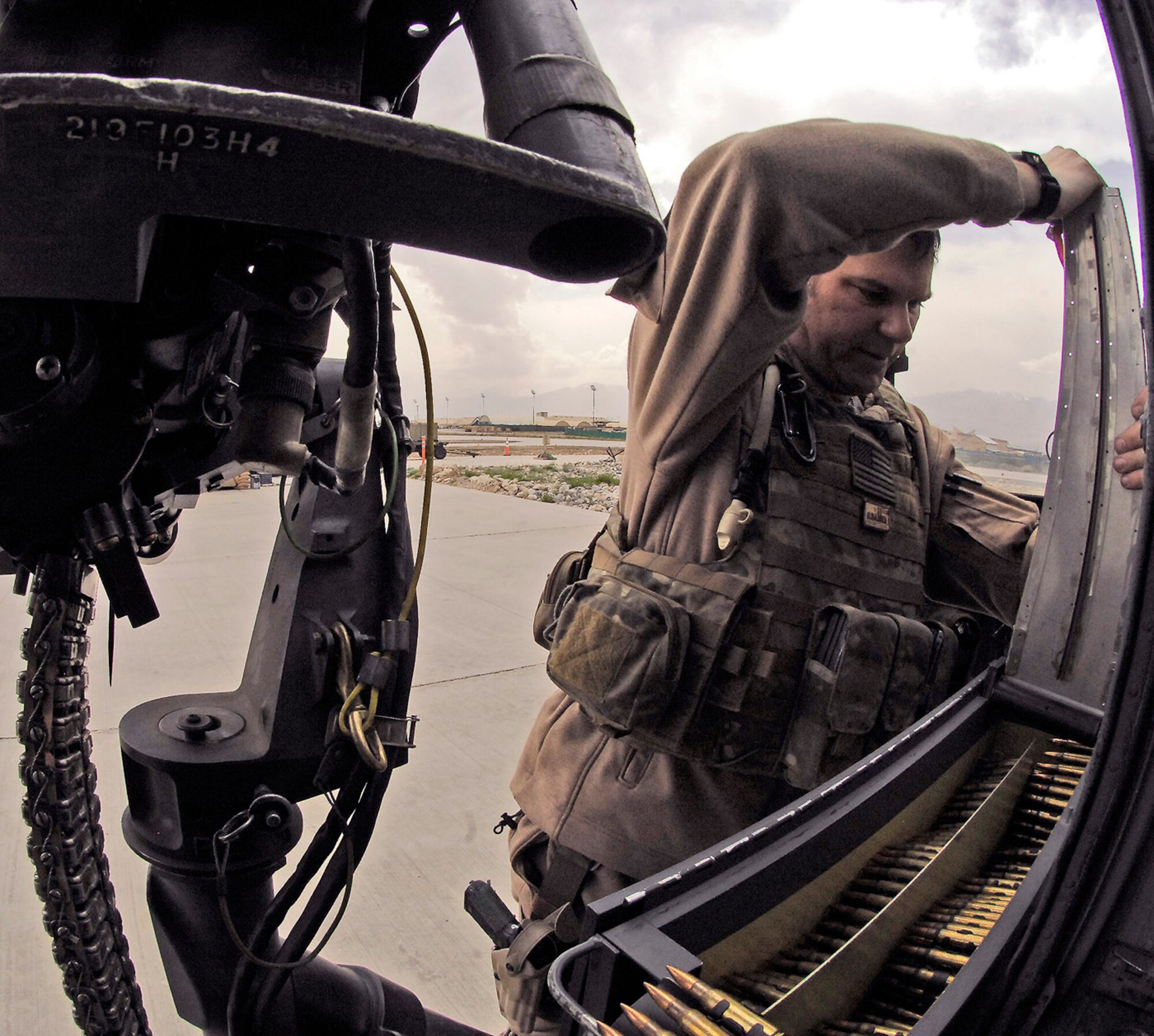 Senior Master Sgt. Glen Berg loads his rail gun on the HH-60 Pave Hawk before taking off on a training mission April 20 at Bagram Airfield, Afghanistan. Sergeant Berg is a 101st Expeditionary Rescue Squadron aerial gunner. (U.S. Air Force photo/Staff Sgt. Jason Lake) 
