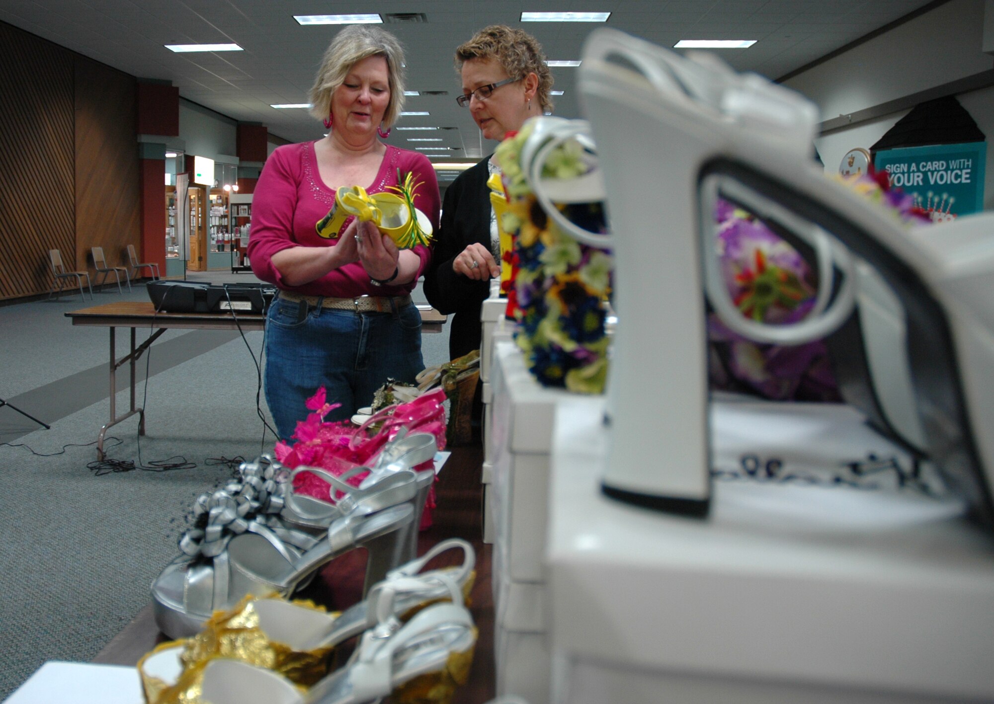 MINOT, N.D. -- Diane Draovitch and Ruth Kim organize high heels during a "walk a mile in her shoes" event at the Town and Country Mall here April 26. The event was designed to raise awareness of sexual assault. 2009 was a year that brought progress and a renewed emphasis on safe, secure and reliable nuclear operations. The 91st Missile Wing transitioned to Air Force Global Strike Command with the 5th Bomb Wing scheduled to follow suit in 2010. (U.S. Air Force photo by Senior Airman Wesley Wright)