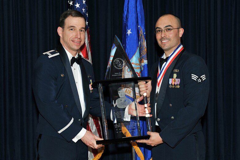 OFFUTT AIR FORCE BASE, Neb. - Capt. Michael Willen, commander of the Heartland of America Band and Senior Airman John D. Beasley, also with the Heartland of America Band, pose for a photograph after Airman Beasley was presented with the John L. Levitow award, during the graduation ceremony for Class 09-D of the James M. McCoy Airman Leadership School, at the Patriot Club April 2. The John L. Levitow award is presented to the top student in each ALS class. Airman Beasley  is one of 45 ALS graduates of Class 09-D. "By completing ALS the graduates enhanced their leadership skills to guide the next generation of Airmen," Col. Thomas Goffus, 55th Mission Support Group commander said. U.S. Air Force photo by Charles Haymond