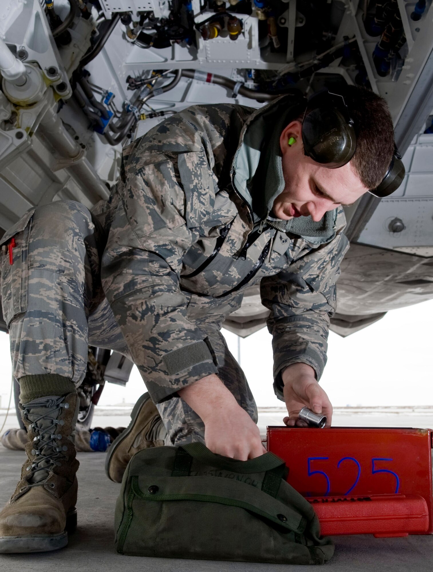 Airman 1st Class Justin Baker grabs tools to setup an F-22 Raptor weapons bay for the loading of a Joint Direct Attack Munition April 14 at Elmendorf Air Force Base, Alaska. Airman Baker, from the 525th Aircraft Maintenance Unit, ensures the JDAM dropped by 525th Fighter Squadron is successful. (U.S. Air Force photo/Senior Airman Jonathan Steffen) 
