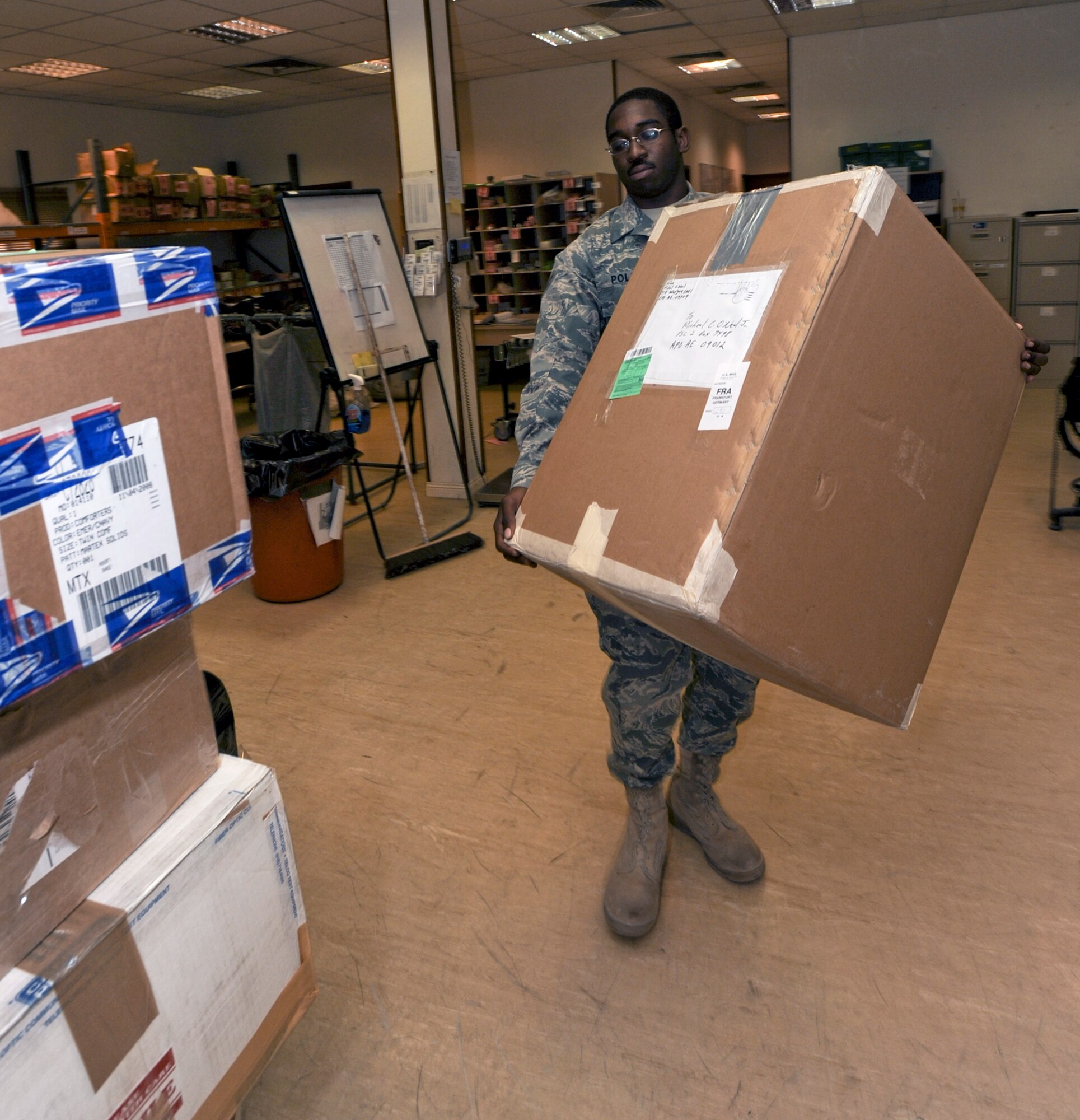Airman 1st Class Cardell Polk stages packages to be picked up later in the day here, April 20 at an air base in Southwest Asia. Throughout the day outgoing mail is prepped for transport to the airport for further delivery. Airman Polk is native to New Orleans and is deployed from Pope Air Force Base, N.C. He is a postal clerk with the 379th Expeditionary Communication Squadron. (U.S. Air Force photo/Staff Sgt. Joshua Garcia) 

