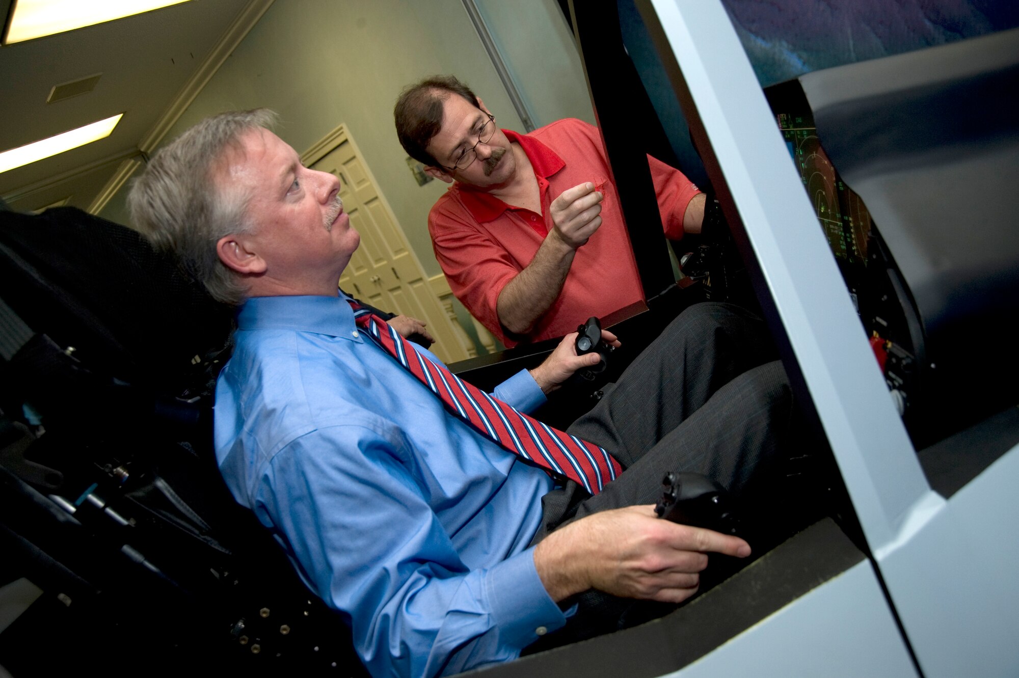 Florida Lt. Gov. Jeff Kottkamp takes a “test drive” in the Joint Strike Fighter cockpit demo at the Eglin officer’s club as part of his visit to the base April 24.  The lieutenant governor also got a close-up tour of the Joint Strike Fighter test aircraft AA-1.  The visit capped a week of events involving the JSF.  The aircraft’s first arrival at the base was to provide a showcase to Team Eglin and the local community.  Media and local community leaders saw and heard the aircraft in action during the sortie as well as got an up close view of it.  They were also shown a cockpit demo to see what it feels like to sit inside an F-35 and learn the pilot’s point of view.  Nine countries and three U.S. services have orders for the new aircraft and they all will pass through Eglin to learn to fly it.  The 33rd Fighter Wing will transition from an operational fighter unit into a joint training unit in October to educate and train the pilots.  The first of new fighters are scheduled to arrive March 2010. U.S. Air Force photo