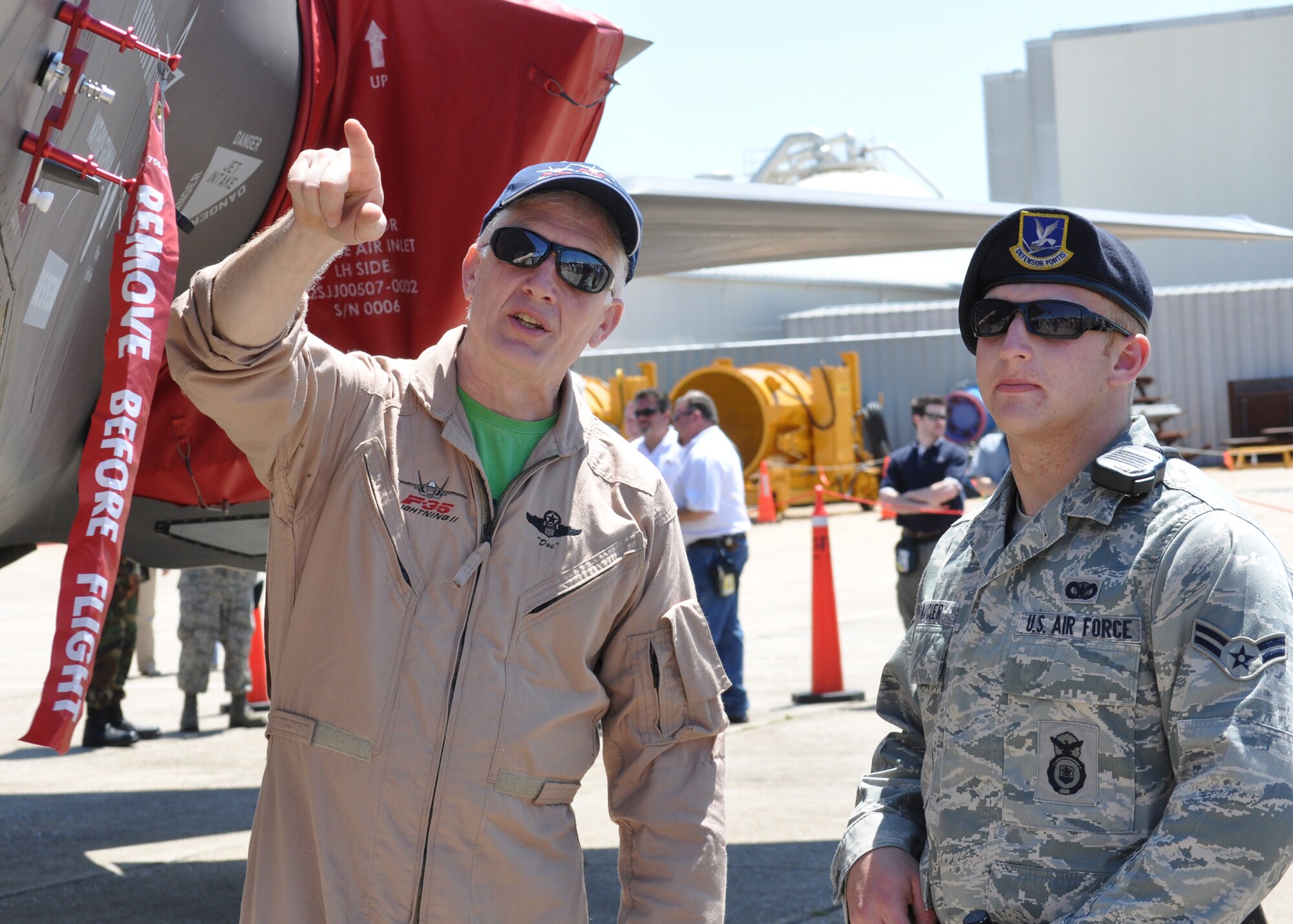 Joint Strike Fighter test pilot David Nelson gives Airman 1st Class Joseph Saucier, 96th Security Forces Squadron, a tour around the F-35, April 23 while it was parked in front of McKinley Climatic Lab on base.  The aircraft’s first arrival at the base was to provide a showcase to Team Eglin and the local community.  Media and local community leaders saw and heard the aircraft in action during the sortie as well as got an up close view of it.  They were also shown a cockpit demo to see what it feels like to sit inside an F-35 and learn the pilot’s point of view.  Nine countries and three U.S. services have orders for the new aircraft and they all will pass through Eglin to learn to fly it.  The 33rd Fighter Wing will transition from an operational fighter unit into a joint training unit in October to educate and train the pilots.  The first of new fighters are scheduled to arrive March 2010. U.S. Air Force photo/Samuel King Jr.
