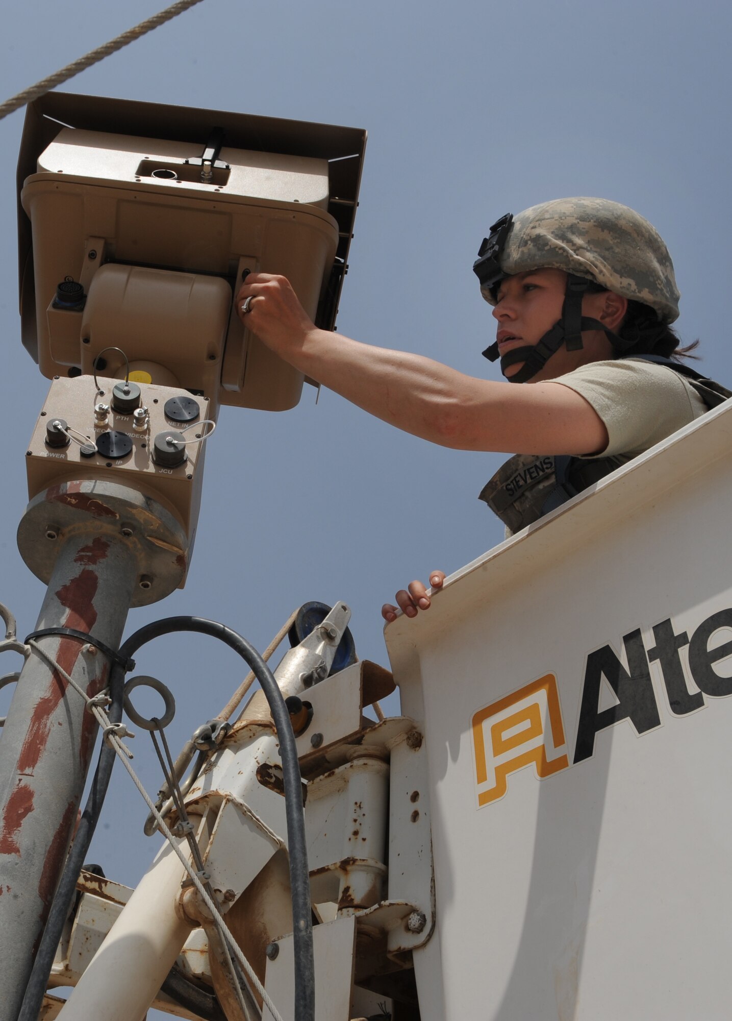 JOINT BASE BALAD, Iraq — Senior Airman Stevi Stevens, 332nd Expeditionary Security Forces Squadron enhanced tactical automated security systems administrator, installs a super long-range thermal imager on a security tower here April 22. The imager is used to monitor inside- and outside-the-wire operations. Airman Stevens is deployed here from McConnell Air Force Base, Kan., and is a native of Kingman, Kan. (U.S. Air Force photo/Senior Airman Elizabeth Rissmiller)