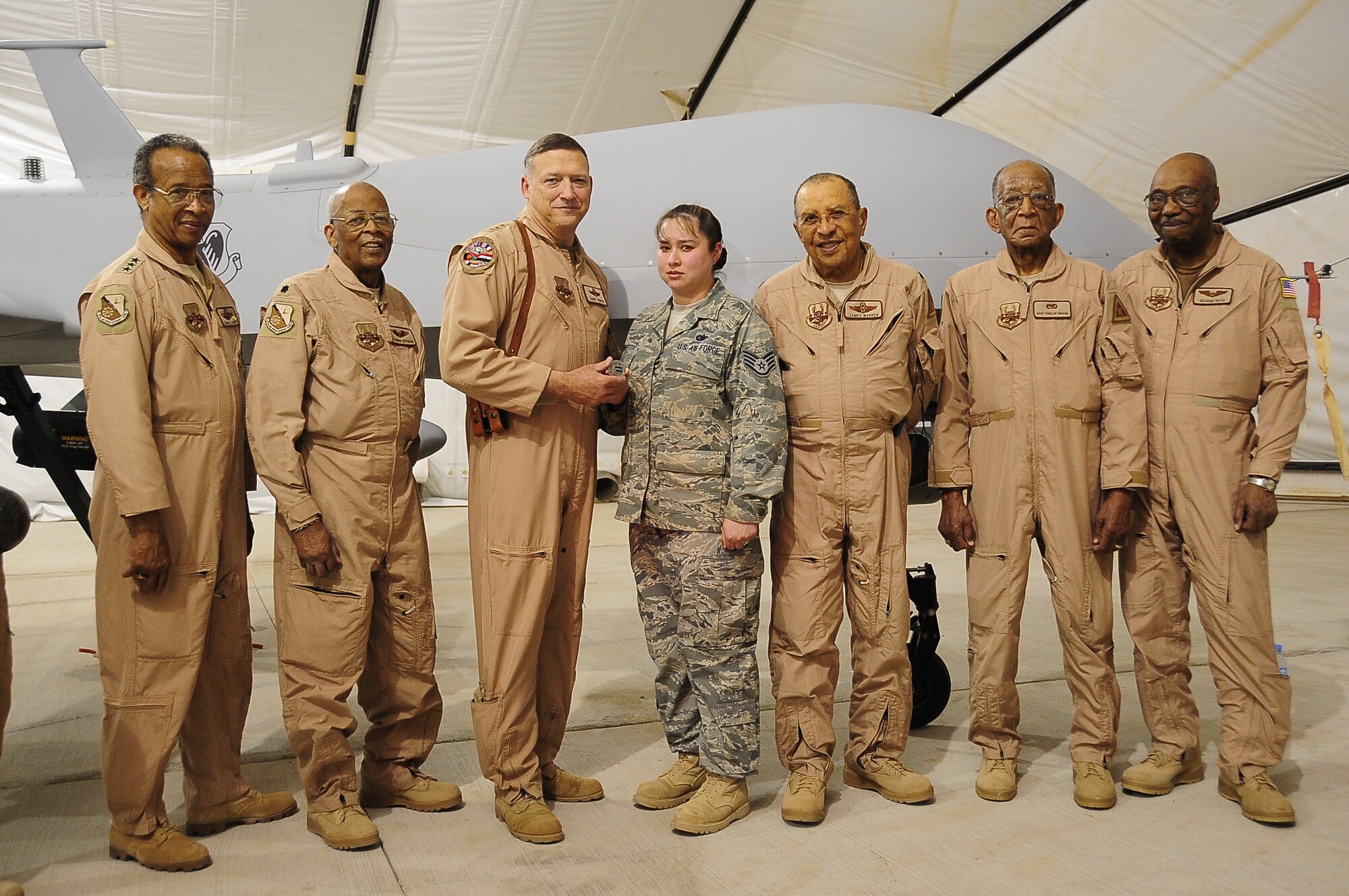 Staff Sgt. Christine Griffith was coined by Lt. Gen. Gary North, air component commander, U.S. Central Command, April 23 for Outstanding Performance. Several Tuskegee Airmen were also present to congratulate her.