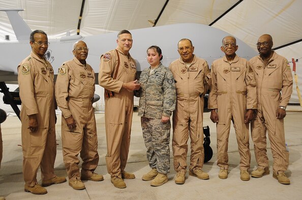 Staff Sgt. Christine Griffith was coined by Lt. Gen. Gary North, air component commander, U.S. Central Command, April 23 for Outstanding Performance. Several Tuskegee Airmen were also present to congratulate her.