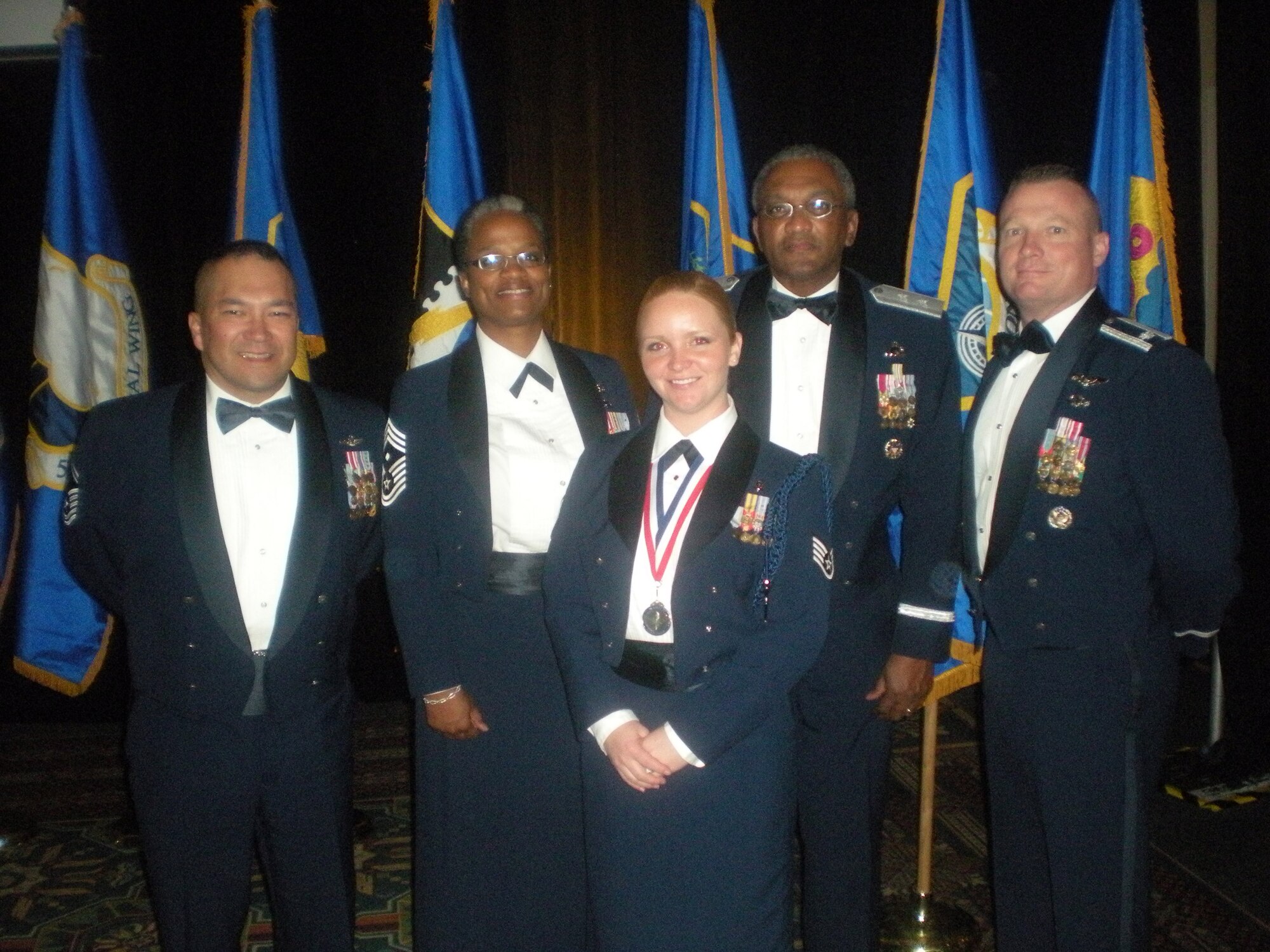 PRESIDIO OF MONTEREY, Calif. -- Staff Sgt. Tabatha Meyers (center), 311th Training Squadron military training leader, was a finalist for the twelve AETC Outstanding Airmen of the Year for 2008 in the base honor guard category. Celebrating with her at the competition banquet are (from left to right) Senior Master Sgt. Leo Chang, 311 TRS superintendent; Chief Master Sgt. Crystal Flowers, 311 TRS first sergeant; Maj. Gen. Alfred Flowers, 2nd Air Force commander, and Lt. Col. Paul Issler, 311 TRS commander. (U.S. Air Force photo)