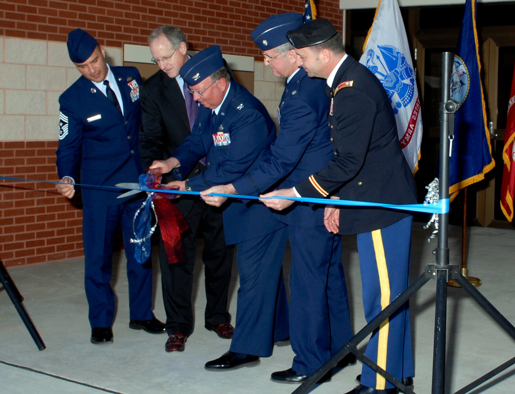 Cutting the ribbon at the grand opening of the new Goodfellow Chapel Tuesday is Col. Richard Ayres (center), 17th Training Wing commander. Colonel Ayres was joined by (from left to right) Chief Master Sgt. Frederick Ricker, 17 TRW command chief master sergeant; United States Congressman Mike Conaway; Chaplain (Lt. Col.) Kevin Cody, 17 TRW chaplain, and Army Lt. Col. Matthew Orenstein, Army Corps of Engineers Fort Worth District deputy commander. The ribbon cutting was the culmination of two years of construction on the new, fully-modern chapel building. Goodfellow’s new chapel is the first the Air Force has built in 16 years. (U.S. Air Force photo by Lou Czarnecki)