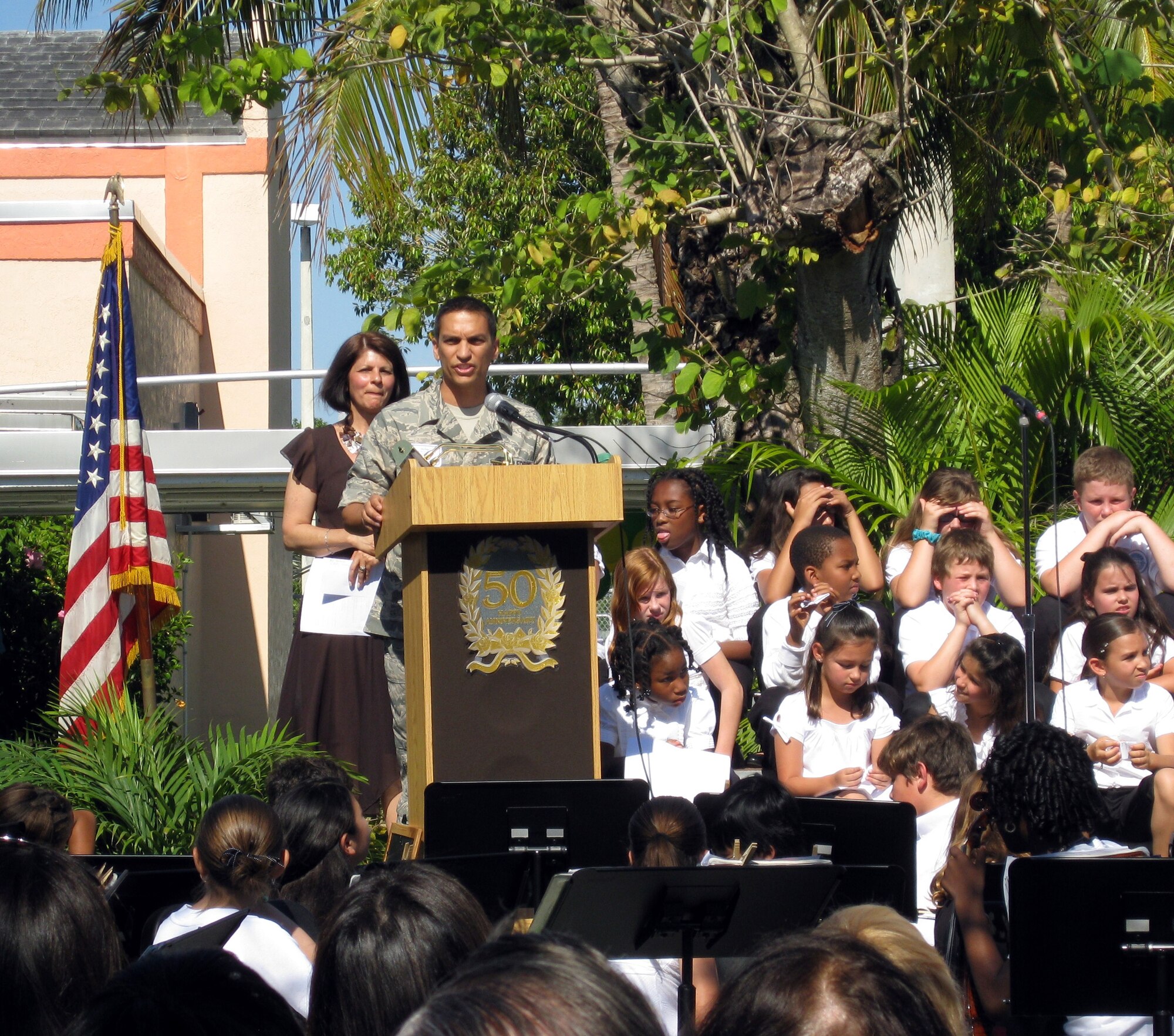 MIAMI -- Master Sgt. Alejandro Mion, 482nd Aircraft Maintenance Squadron F-16 crew chief, speaks to students and faculty at Vineland K-8 Center during the school's 50th Anniversary Celebration on April 24. Sergeant Mion presented the school and principal, Mrs. Mary Ann McLaren, a U.S. flag and certificate he had flown over the skies of Iraq in the school's honor. Sergeant Mion attended the Miami school from 1984 to 1987.  (Courtesy photo)