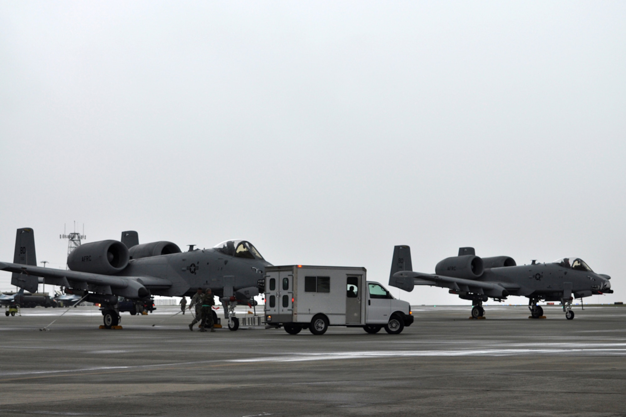 Airmen from the 917th Wing at Barksdale Air Force Base, La., scramble to secure A-10 Thunderbolts on the ramp as a white wall of rain bears down on the jets at the Savannah Combat Readiness Training Center in Savannah, Ga., April 2, 2009. Airmen from the 917th WG and the 47th Fighter Squadron both from Barksdale were involved in training Joint Terminal Attack Controllers for 13 days during “Patriot Dixie.” (US Air Force photo/Tech. Sgt. Jeff Walston)