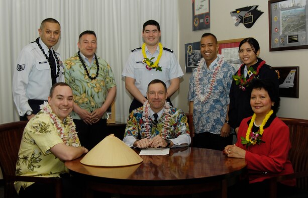 HANSCOM AIR FORCE BASE, Mass. – Col. David Orr, 66th Air Base Wing commander, signs a proclamation declaring May as Asian Pacific American Heritage Month. Members of the APAHM committee joined Colonel Orr for the proclamation signing. Pictured from left to right (front row) Capt. Lee Akers, Colonel Orr, Angie Fedukowski, (back row) Staff Sgt. Robert Mebane, Tech. Sgt. Donald Milliman, First Lieutenant Will Russell, Col. Henry Pandes, Second Lieutenant Rachel Oakes. (U.S. Air Force photo by Linda LaBonte Britt)