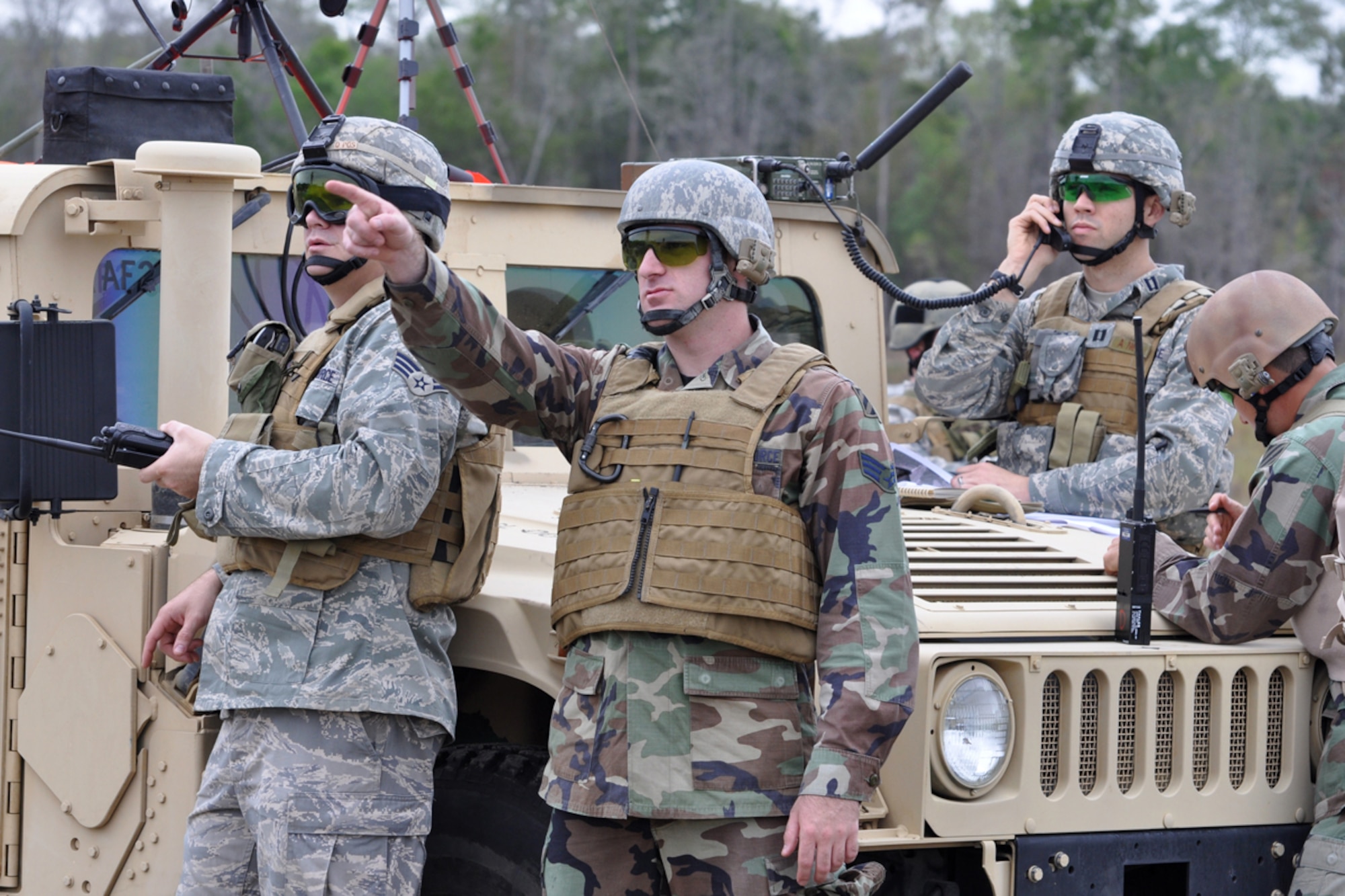 (L-R) Senior Airmen Tim Johnson, joint terminal attack controller (JTAC), and Dave Pedersen, radio operator maintainer and driver (ROMAD), watch an incoming aircraft as Capt. Christopher Schulz, air liaison office/JTAC, talks the aircraft on to a target. The Airmen are members of the 15th Air Support Operations Squadron and are embedded with the Army’s 3rd Infantry Division at Fort Stewart, Ga. The Airmen are involved in a 13 day training exercise for Joint Terminal Attack Controllers in the Savannah, Ga., area. (US Air Force photo/Tech. Sgt. Jeff Walston)    