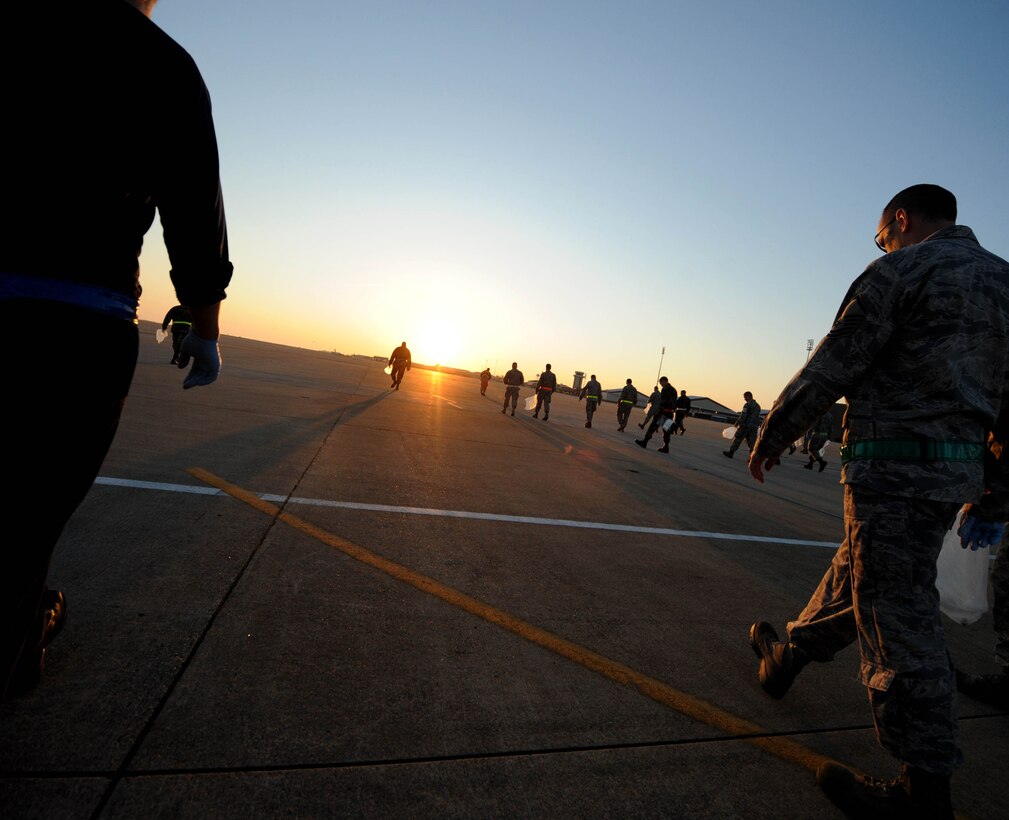 LANGLEY AIR FORCE BASE, Va. -- Airmen pick up foreign object debris on the flightline April 27. The post-air show FOD walk cleaned up what was left behind from the fun filled weekend of exhibiting aircraft and showing appreciation to the local community. (U.S. Air Force photo/Airman Rebecca Montez)