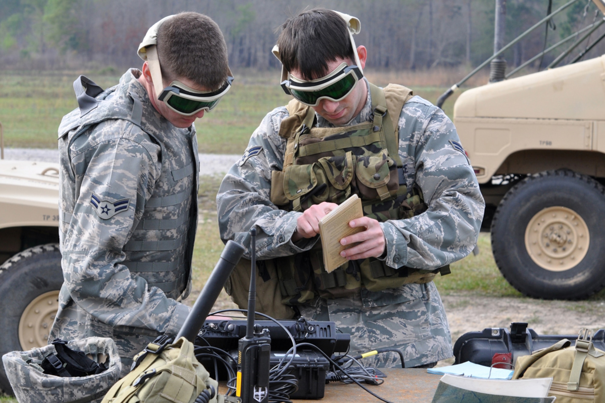 Airman 1st Class John Kingsley, radio operator maintainer and driver, 682nd Air Support Operations Squadron, Shaw Air Force Base, S.C., and Airman 1st Class Chad Hutsell, ROMAD, with the 15th ASOS, Ft. Stewart, Ga., work with a military rugged tablet (MRT) during “Patriot Dixie,” March 31, 2009. The MRT is a computer system that sends digital information to combat aircraft providing close-air-support much like text messaging. Both Airmen are involved in a 13 day training exercise for Joint Terminal Attack Controllers in the Savannah, Ga., area. (US Air Force photo/Tech. Sgt. Jeff Walston)