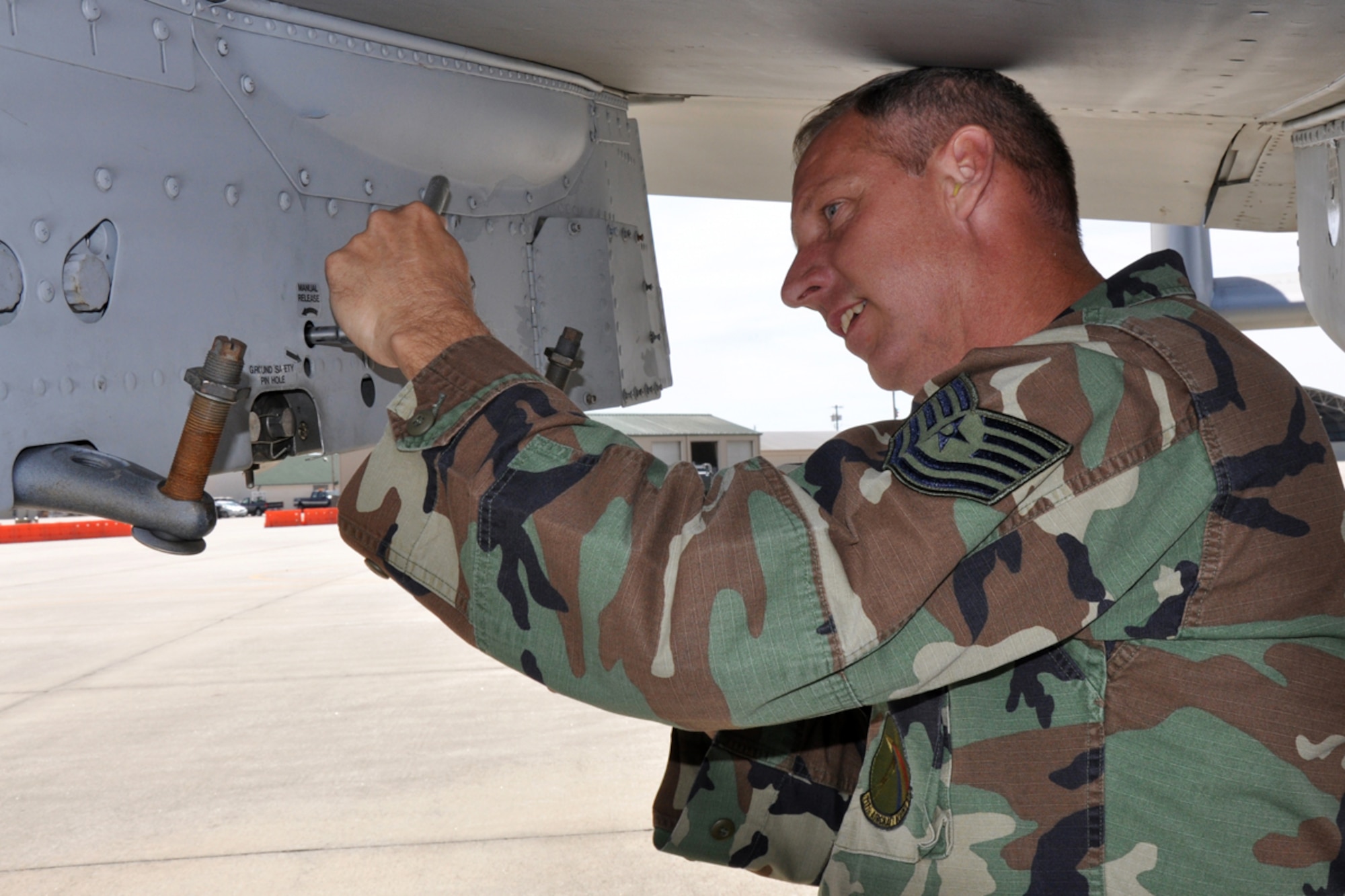 Technical Sgt. Alan Leeps, avionics specialist, 717th Aircraft Maintenance Squadron, Barksdale Air Force Base, La., opens rack hooks on an A-10 Thunderbolt to load a LITENING (targeting) pod March 30, 2009. Airmen from the 717th AMXS maintained A-10 jets from the 47th Fighter Squadron at Barksdale AFB, while they supported training evolutions for Joint Terminal Attack Controllers with the 15th Air Support Operations Squadron at Fort Stewart, Ga. (US Air Force photo/Tech. Sgt. Jeff Walston) 