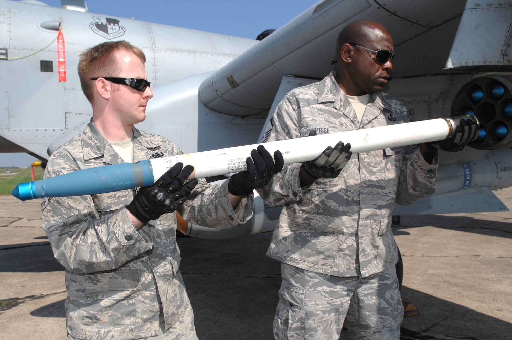 BEZMER AIR BASE, Bulgaria – Senior Airman Bryan Fleetwood and Master Sgt. George Price Jr., 52nd Civil Engineer Squadron Explosive Ordinance Disposal team members, download a training rocket from an A-10 Thunderbolt II.  The two-man team deployed to Bezmer Air Base, Bulgaria to support a U.S. and Bulgarian Air Forces training exercise. (U.S. Air Force photo by Master Sgt. Bill Gomez) 