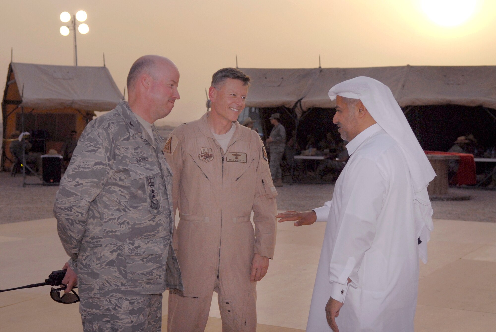 Colonel Paul Guemmer, 379th Air Expeditionary Wing Vice Commander, and Brigadier Gen. Michael Moeller, 379th Air Expeditionary Wing Commander, talk with Brigadier Gen. Abdullah Jassim Al Muraikhi, during the Texas Style barbeque cultural event hosted by the 379th Air Expeditionary Wing, April 23, 2009, at an undisclosed location in Southwest Asia.  During the event coalition members and host nation guests participated in throwing horseshoes and a lasso, riding a mock mechanical bull, and eating Texas style food, to share some American culture.  The servicemembers who participated in this event are deployed in support of Operations Iraqi and Enduring Freedom and Combined Joint Task Force - Horn of Africa.  (U.S. Air Force photo/Senior Airman Andrew Satran/released)