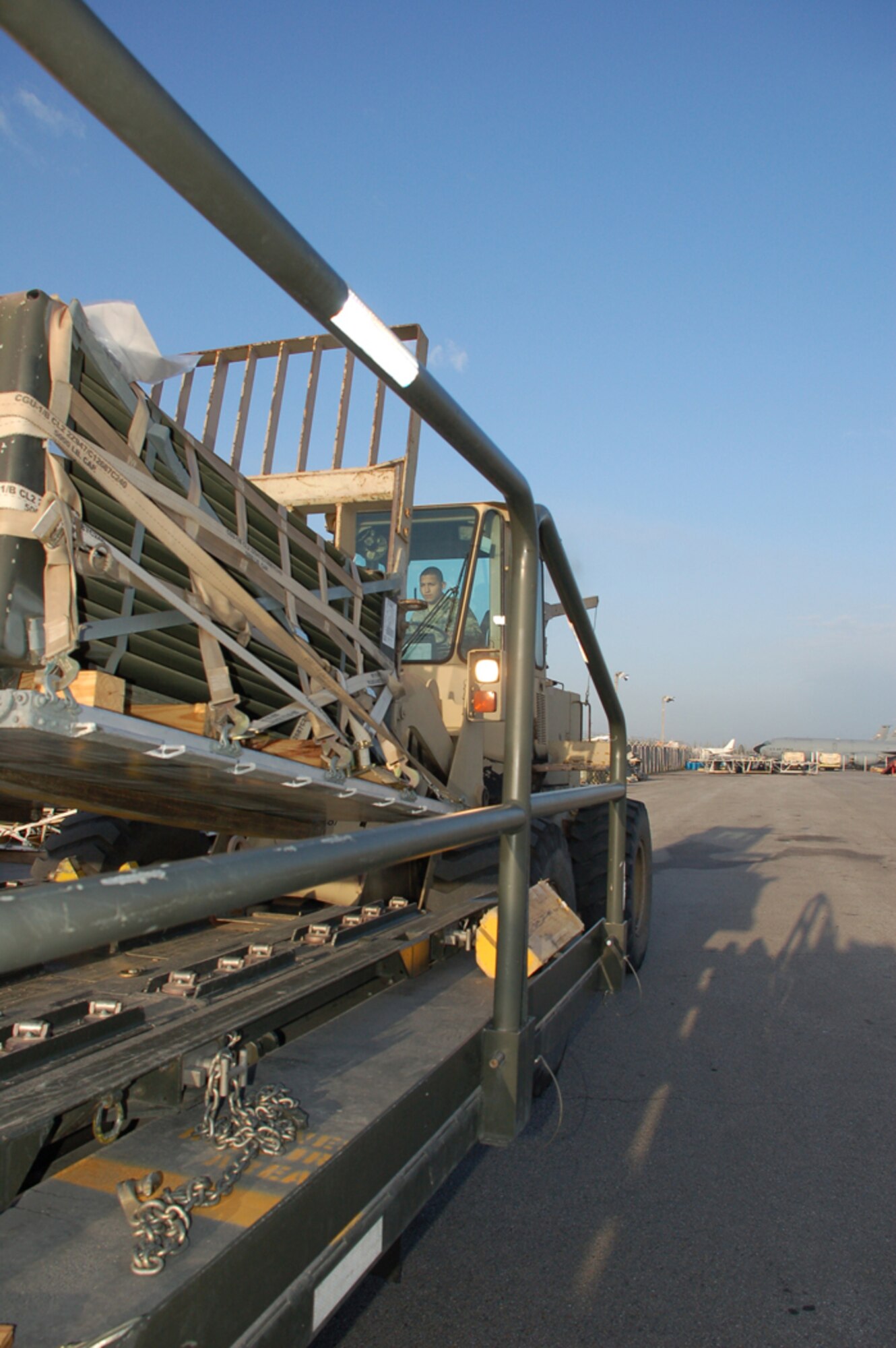 Airman 1st Class Roberto Armas, an air transportation journeyman with the 376th Expeditionary Logistics Readiness Squadron, unloads pallets April 18 from inside the Air Terminal Operations Center cargo yard at Manas Air Base, Kyrgyzstan. For the past five weeks the ATOC has been supporting three C-17 aircrews from Pacific Air Forces who have been flying three flights nearly every day in order to deliver needed supplies to support the buildup of various bases supporting Operation Enduring Freedom. Airman Armas is deployed from the 62nd Aerial Port Squadron at McChord Air Force Base, Wash. (U.S. Air Force photo/Tech. Sgt. Phyllis Hanson)