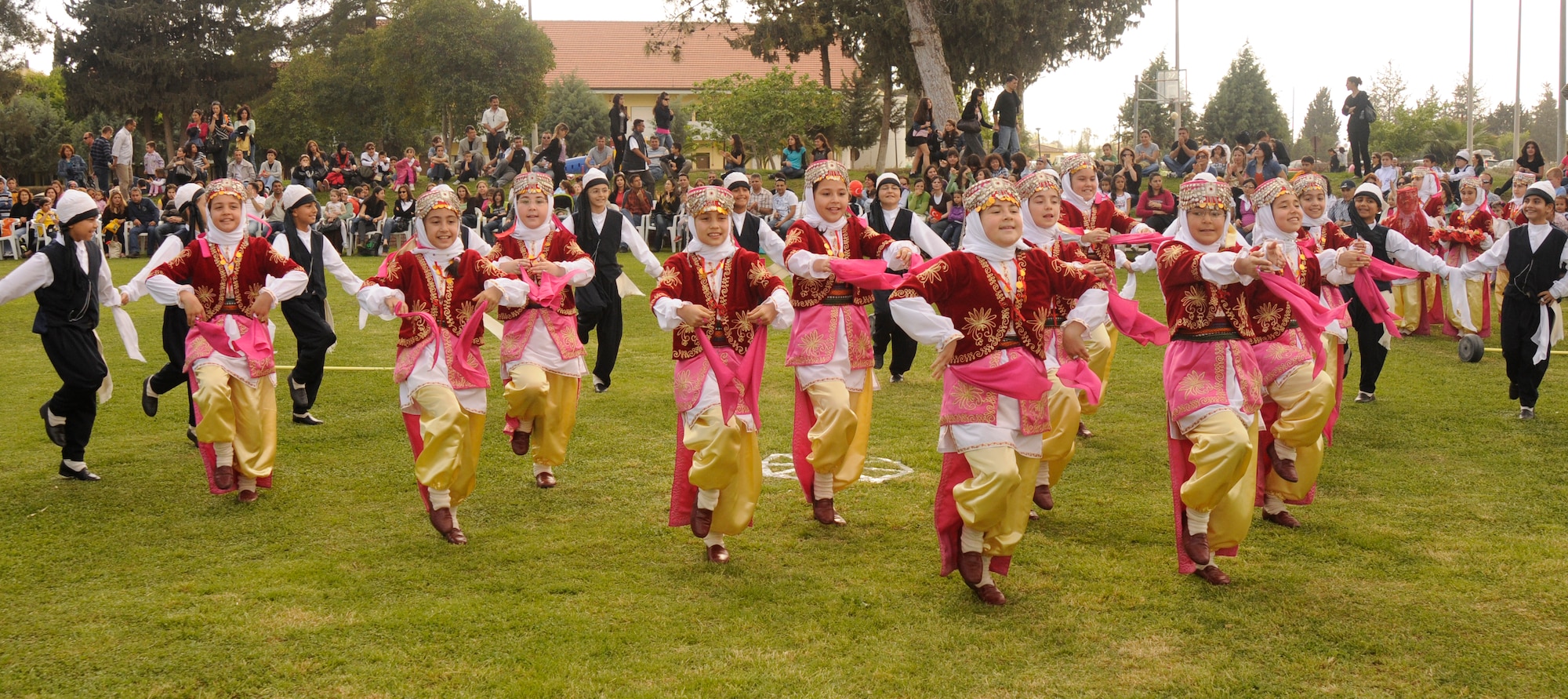 A group of Turkish children perform a traditional dance for the crowd at the Turkish Children’s Festival April 23, 2009 at Arkadas Park at Incirlik Air Base, Turkey.  The day was celebrated with traditional folk dances, a Tae Kwon Do show, races and local Turkish food.  More than 200 people were in attendance to the festival, a mix of American and Turkish families from the base.  (U.S. Air Force photo/Amber Russell)