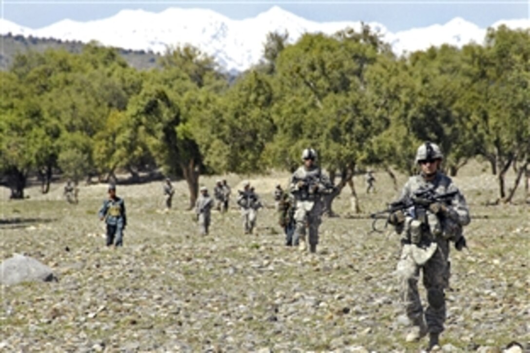 U.S. Army soldiers and Afghan National Police cross a clearing during a patrol near Combat Outpost Sabari, Afghanistan, April 24, 2009. The soldiers are assigned to the 25th Infantry Division's 1st Battalion, Company D, 501st Infantry Regiment, 4th Brigade Combat Team.