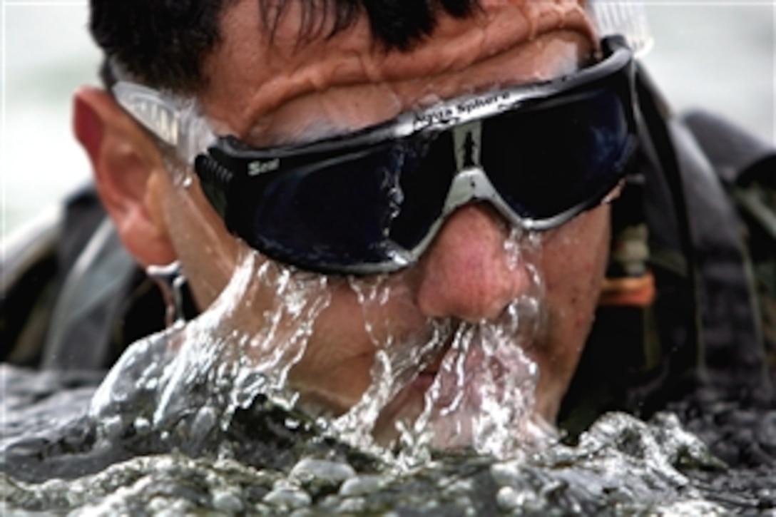 U.S. Marine Corps Sgt. Brandon Wray takes a breath as he snakes his way through the water toward the beach during hydrographic survey training on Camp Schwab, Okinawa, Japan, April 13, 2009. Wray is a team leader assigned to the 3rd Marine Division's Alpha Company, 3rd Reconnaissance Battalion.
