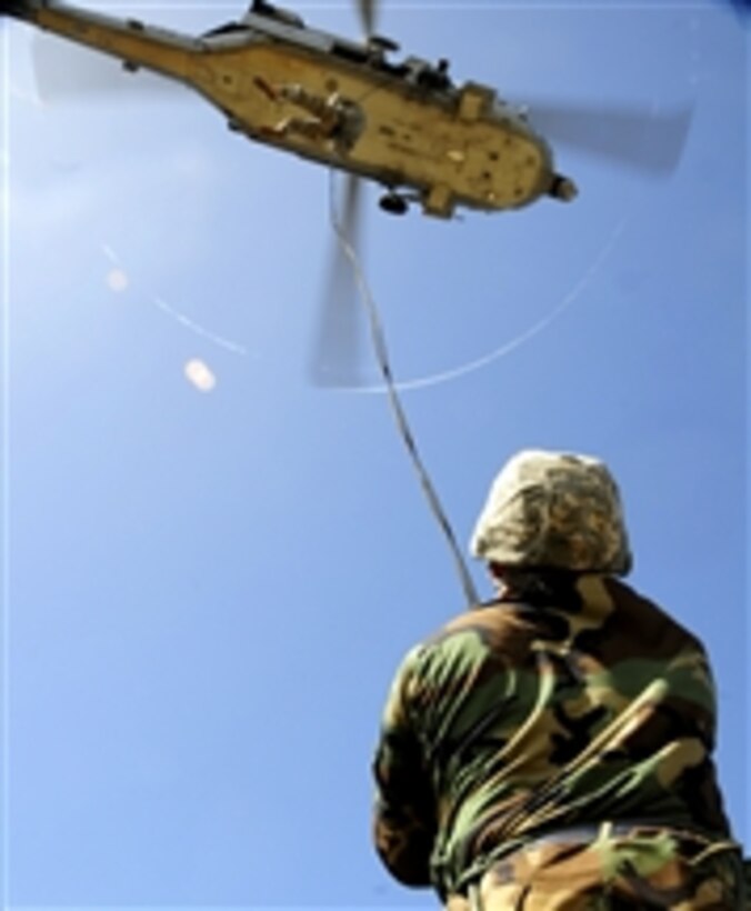 U.S. Air Force airmen from the 554th Red Horse Squadron conduct rappelling and fast-roping techniques during their field training exercise at Northwest Field, Andersen Air Force Base, Guam, on April 23, 2009.  The 554th Red Horse engineers are participating in a two-day field training exercise to hone expeditionary skills to open a base in any environment.  