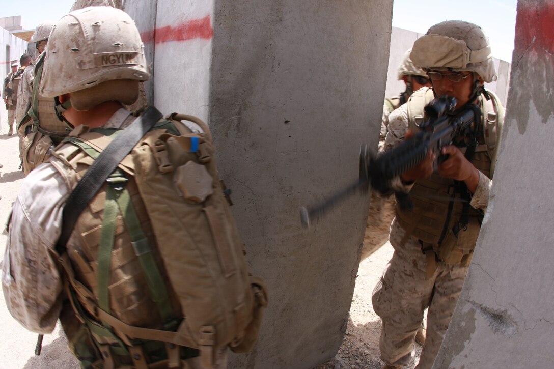 Marines with Company C, 1st Tank Battalion, enter the first of many doors at the Combat Center’s Range 111 April 28 during their urban assault training. The company conducted the operation as part of their pre-deployment training process.