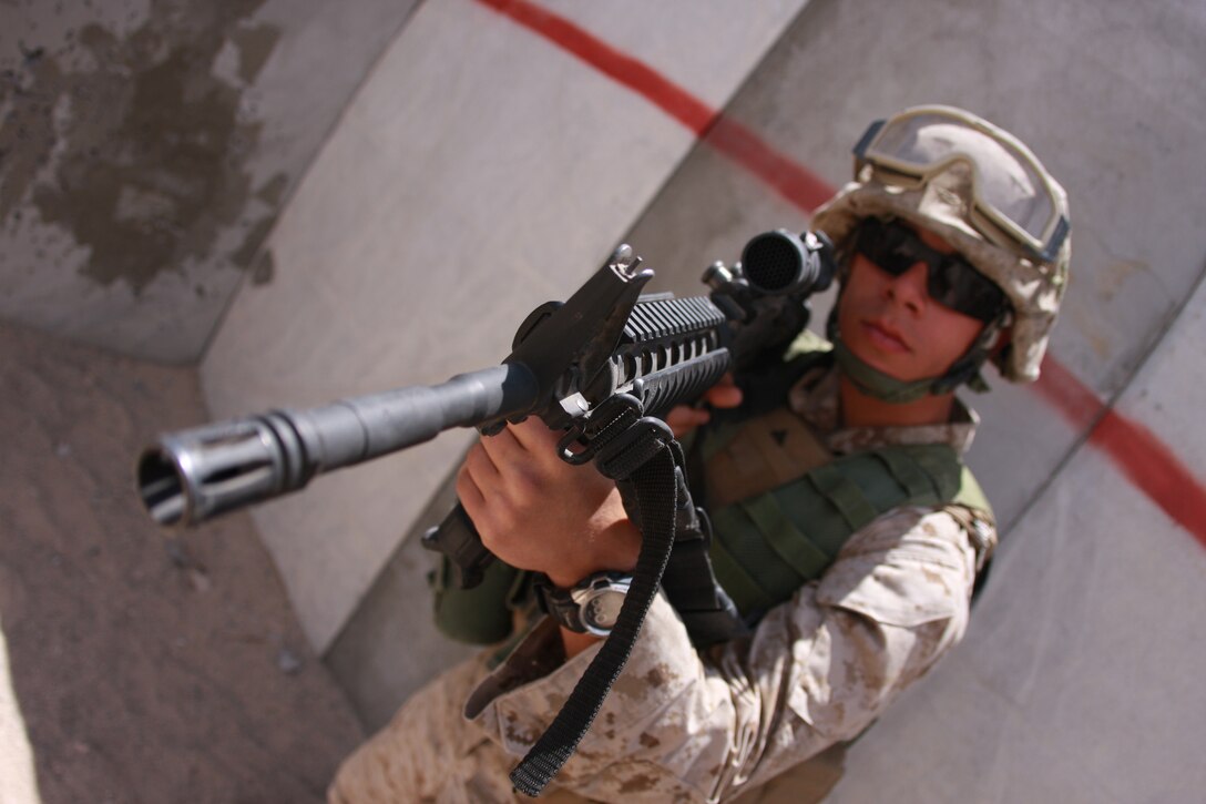 Lance Cpl. Jonathan Guadardo, a tank crewman with Company C, 1st Tank Battalion, scans a room as the rest of the team he is with clears their sections. The company undertook urban warfare training April 28 at the Combat Center’s Range 111 as part of their pre-deployment training process.