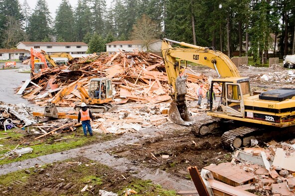 Equity Residential workers load scrap wood into a pile which will be trucked to a
steam plant in Everett where it will be used for fuel. (U.S. Air Force photo/Abner Guzman)